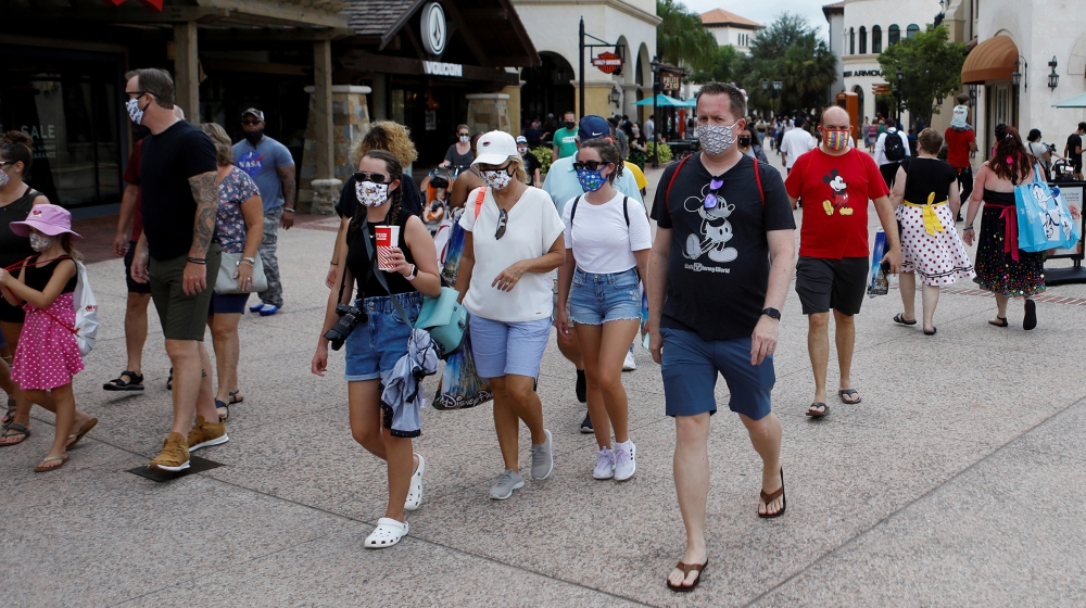 Disney Springs shoppers wear face masks and Disney-themed clothing while Walt Disney World conducts a phased reopening from coronavirus disease (COVID-19) restrictions in Lake Buena Vista, Florida, U.