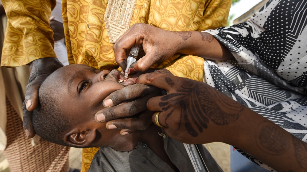 A Health worker administers a vaccine to a child during a vaccination campaign against polio at Hotoro-Kudu, Nassarawa district of Kano in northwest Nigeria. The World Health Organization (WHO) is to
