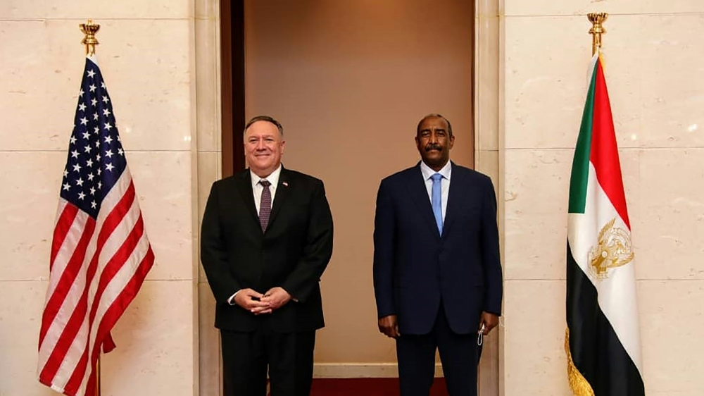 A handout picture provided by Sudan''s Foreign Media Council shows US Secretary of State Mike Pompeo (L) posing for a picture with Sudan''s Sovereign Council chief General Abdel Fattah al-Burhan in Khar