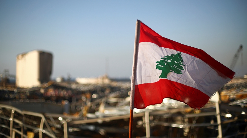 A Lebanese flag is pictured, in the aftermath of a massive explosion, in Beirut's damaged port area, Lebanon August 17, 2020. REUTERS/Hannah McKay