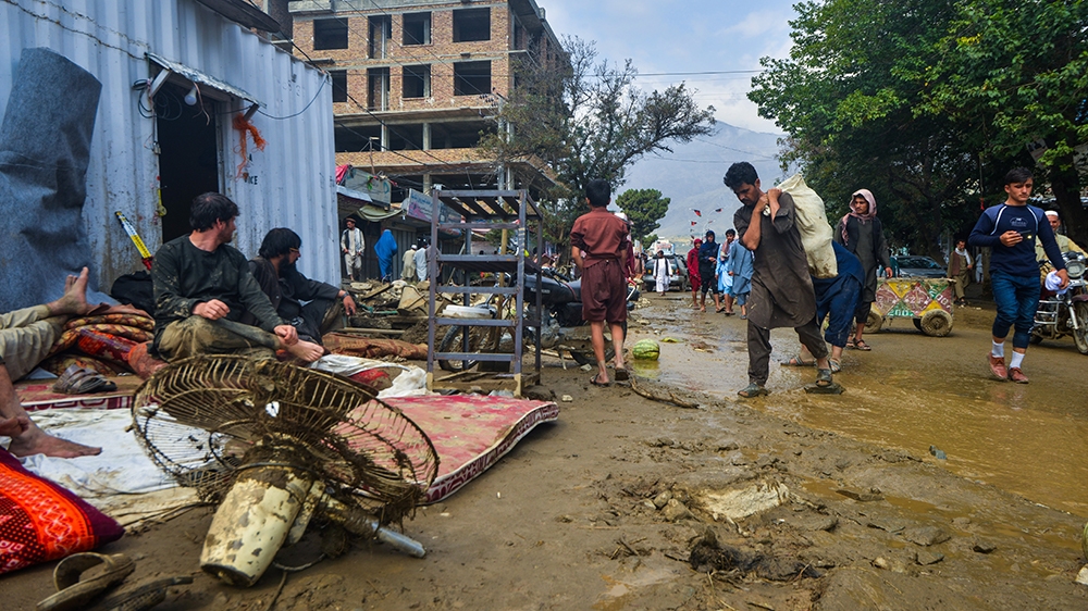People go around a market area after a flash-flood in Charikar, Parwan province, on August 26, 2020. - At least 46 people have been killed and hundreds of houses destroyed by flash floods as torrentia