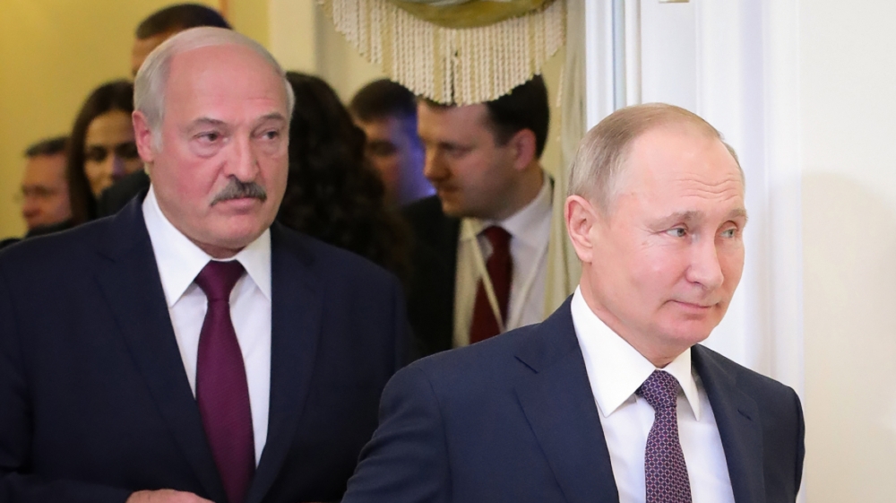 (FILES) This file photo taken on December 20, 2019 shows Russian President Vladimir Putin (R) followed by Belarusian President Alexander Lukashenko (L), entering a meeting hall