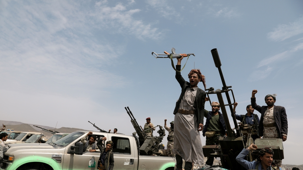Houthi fighters shout slogans during a gathering of Houthi loyalists on the outskirts of Sanaa