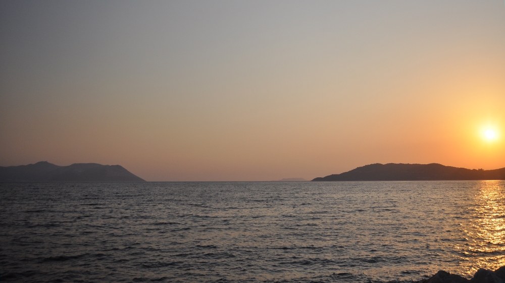 Sun sets on Turkey (right) and Kastellorizo (left) [Samuel Kent/Al Jazeera]