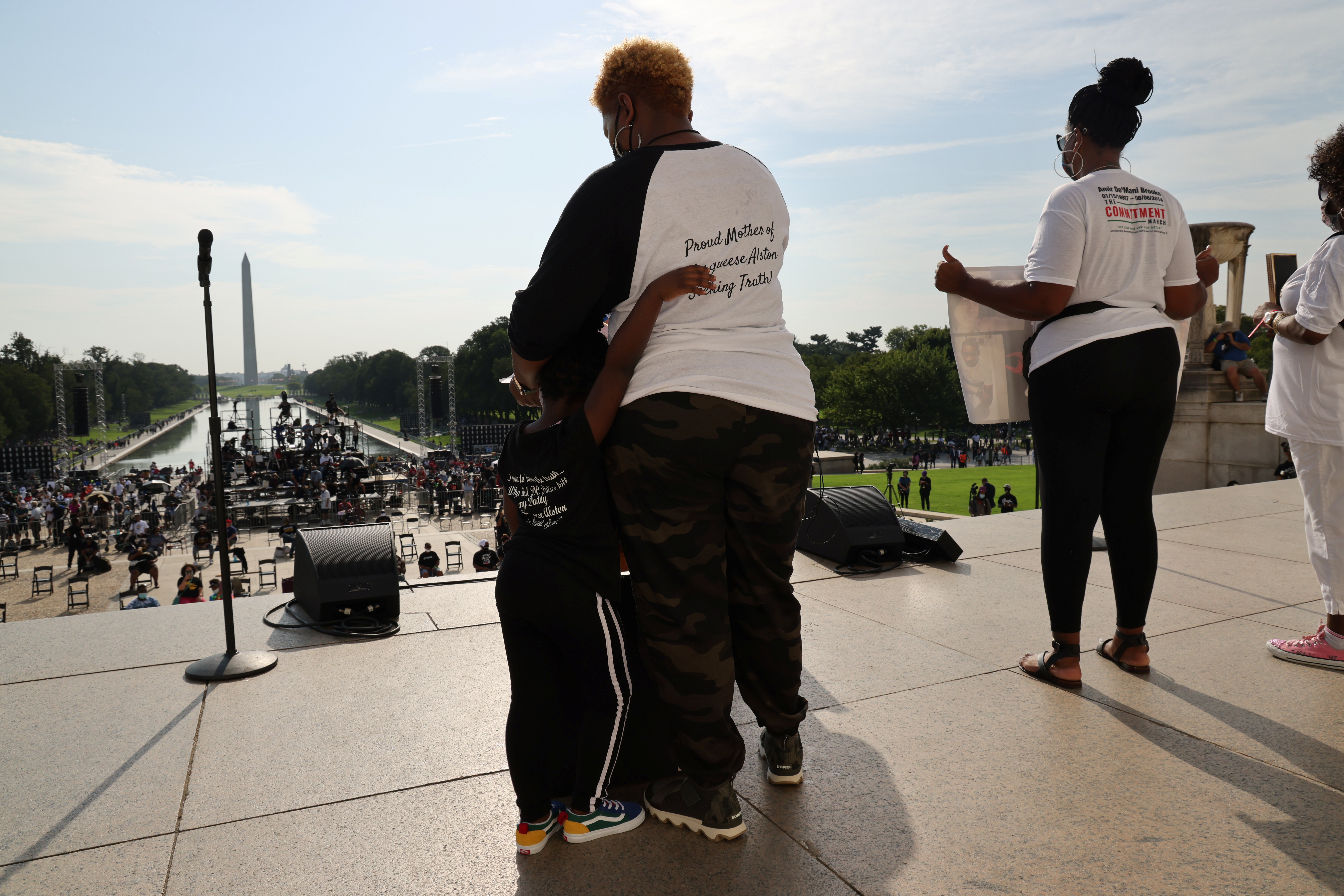 Woman hugging child at top of Lincoln Memorial steps during protest