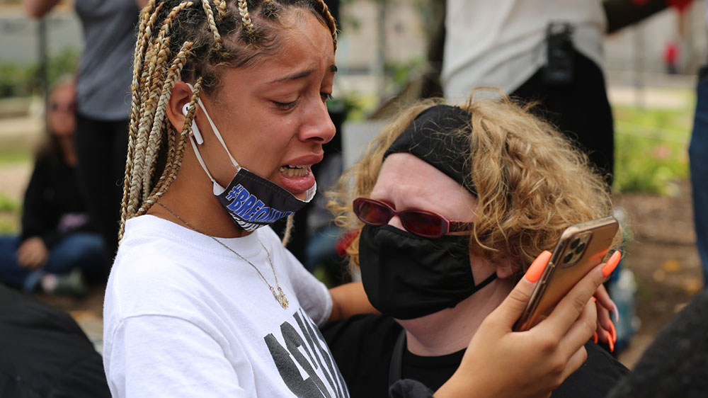 Protesters cry after learning there will be no murder charges in the case [Chris Kenning/Al Jazeera]