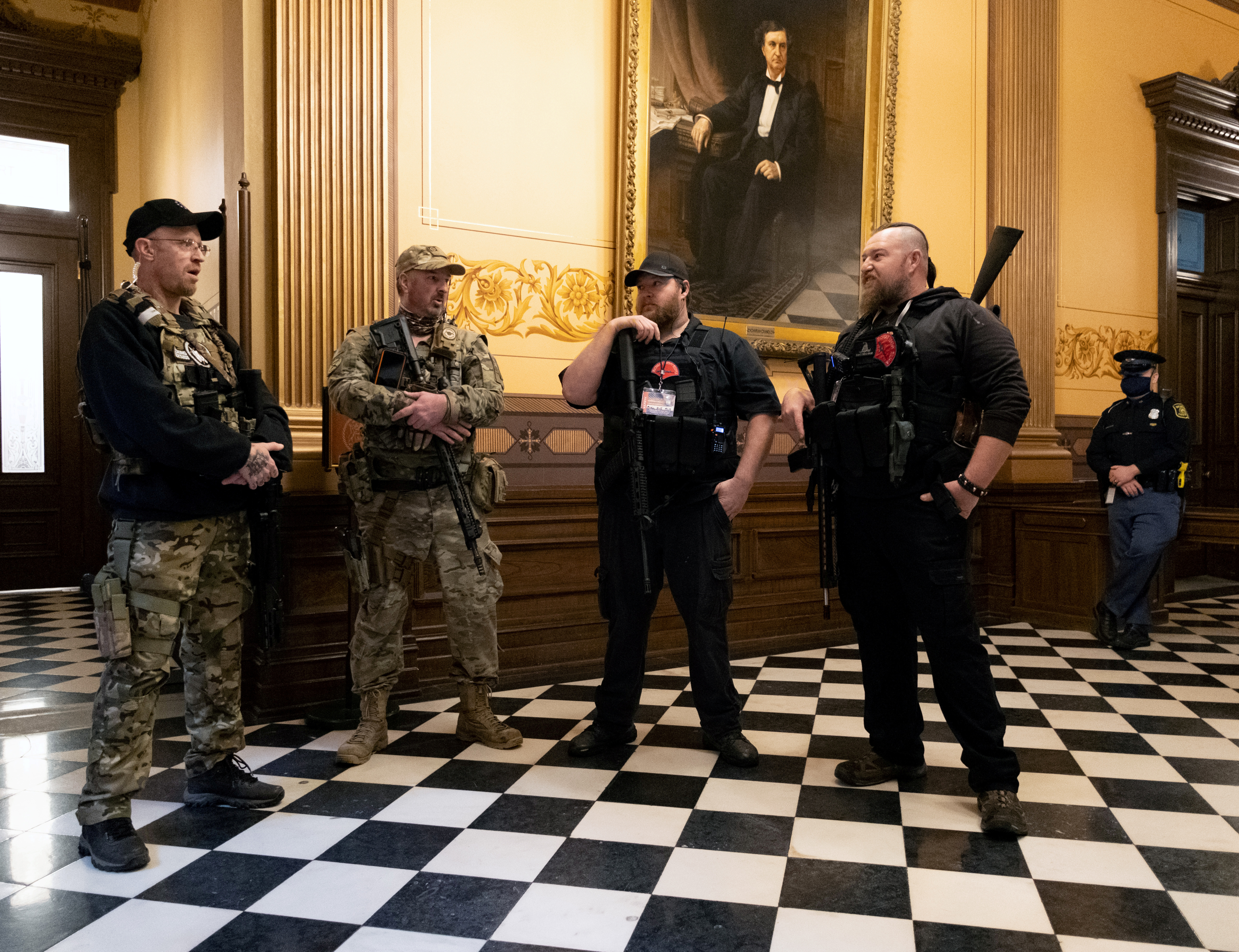 Members of a militia stand in the Capitol Hill building in Lansing, Michigan on April 30, 2020 [Seth Herald/Reuters]