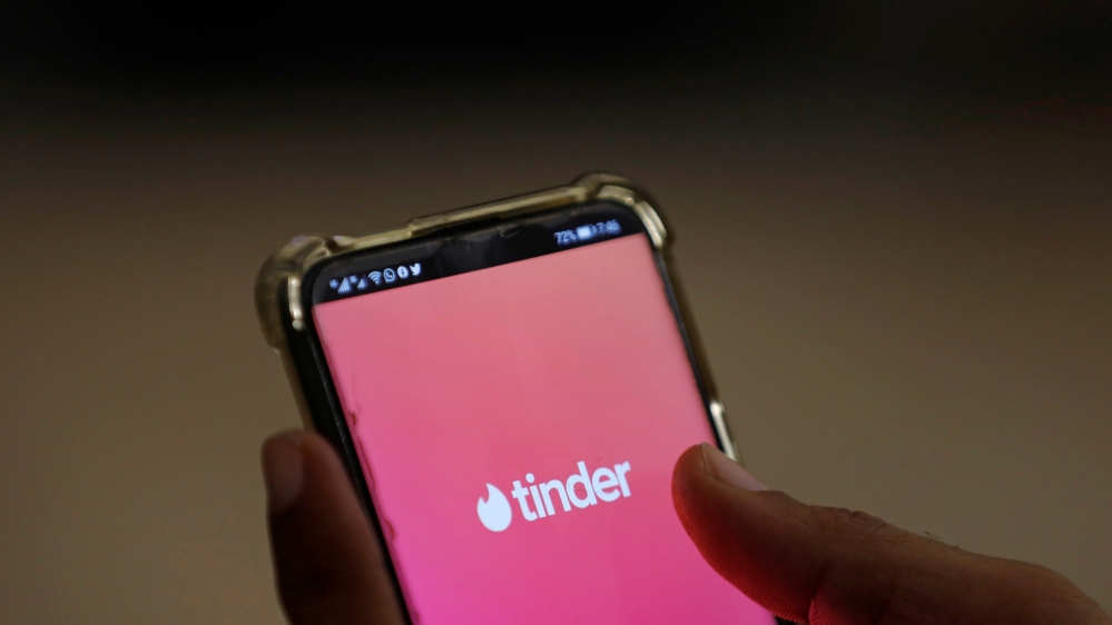 The dating app Tinder is shown on a mobile phone in this picture illustration