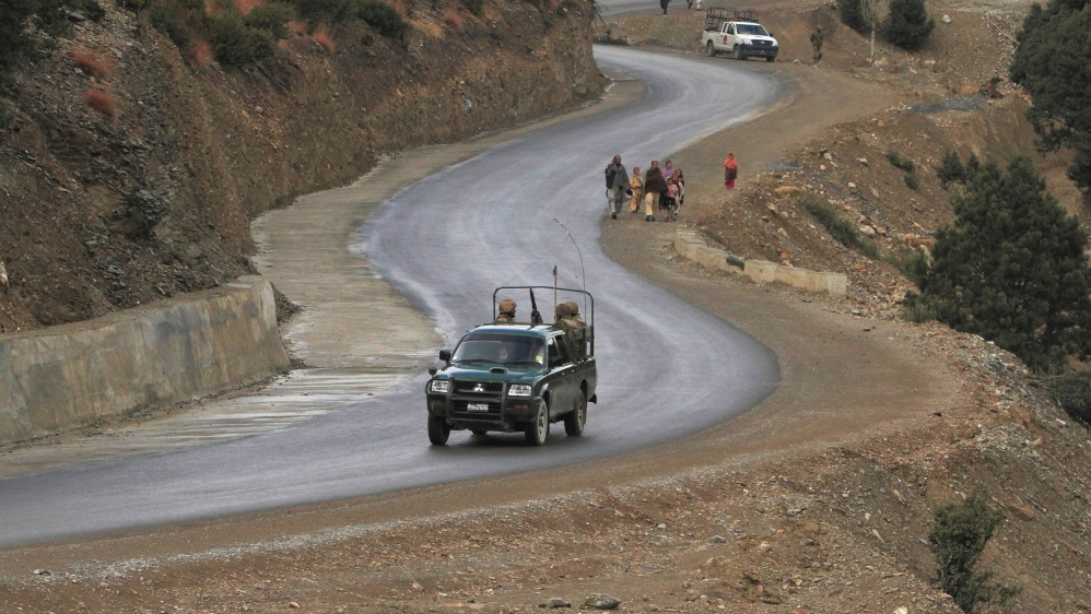 Pakistani soldiers drive in a military jeep.