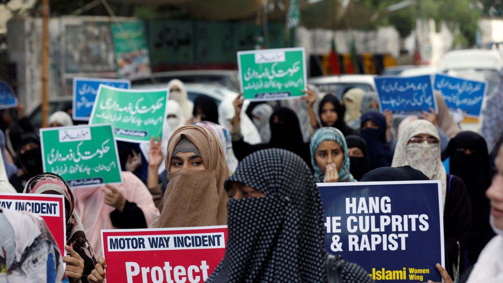 People carry signs to condemn the violence against women and girls, during a demonstration in Karachi