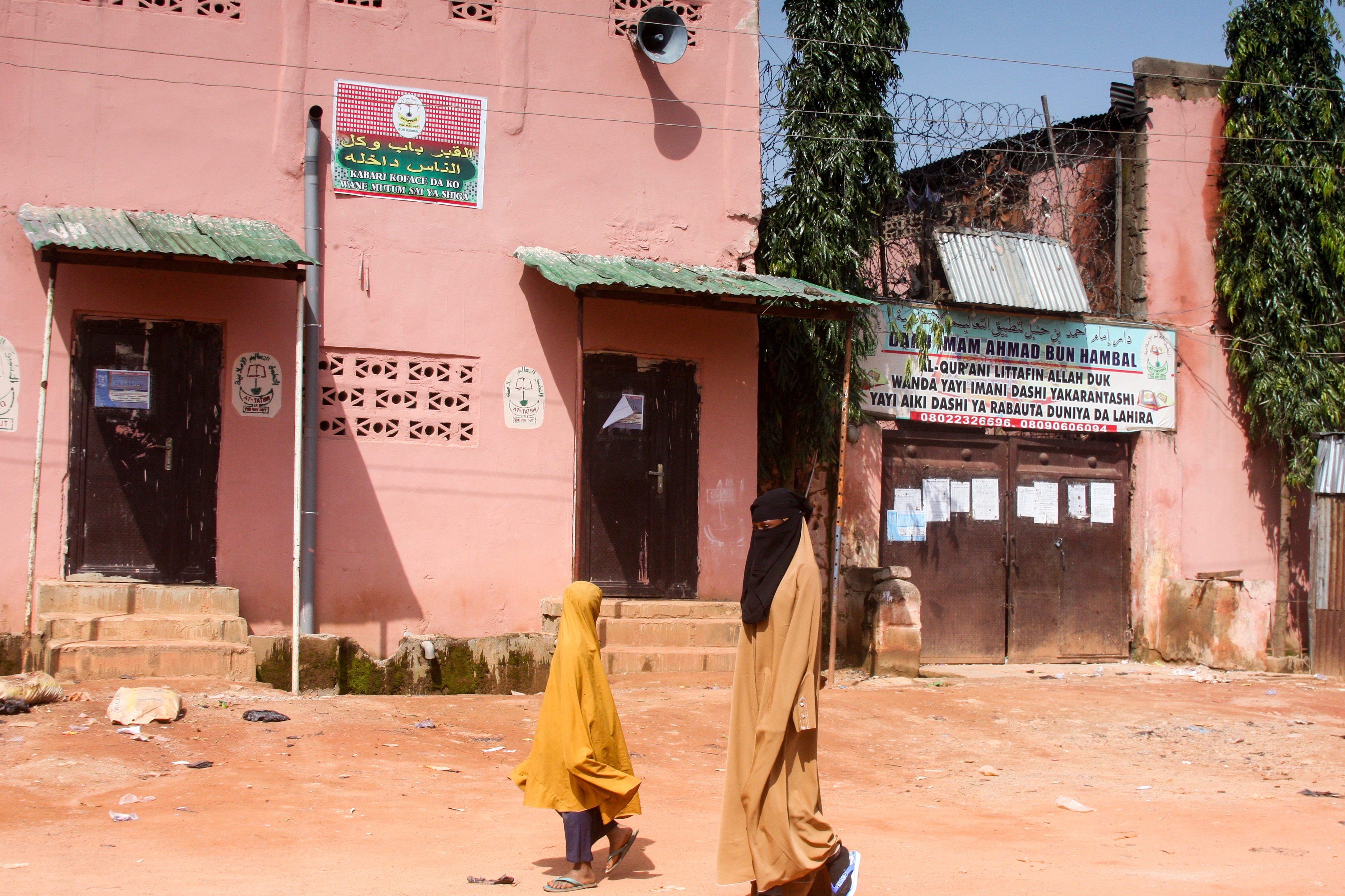 Young girls walk past a boarding school in Kaduna, in northern Nigeria, where hundreds of students who were abused were rescued last year [File: AFP]