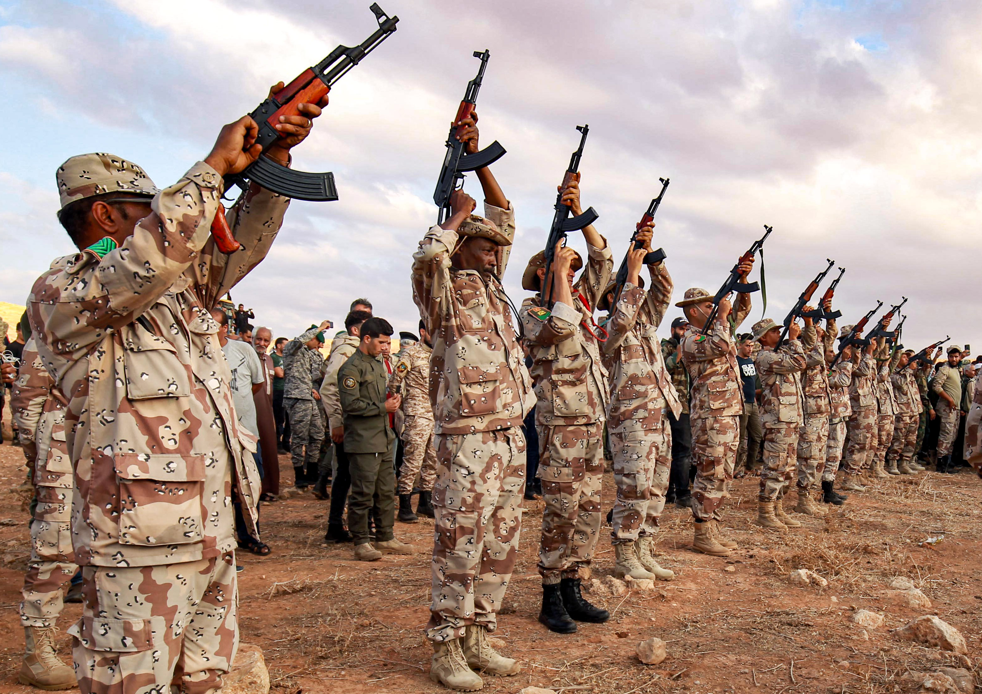 Fighters fire salutatory rounds in the air during the funeral of General Wanis Bukhamada, commander of the "Saiqa" (Special Forces) of the self-proclaimed Libyan National Army (LNA) loyal to strongman Khalifa Haftar, in the eastern city of Benghazi on November 1, 2020. (Photo by Abdullah DOMA / AFP)