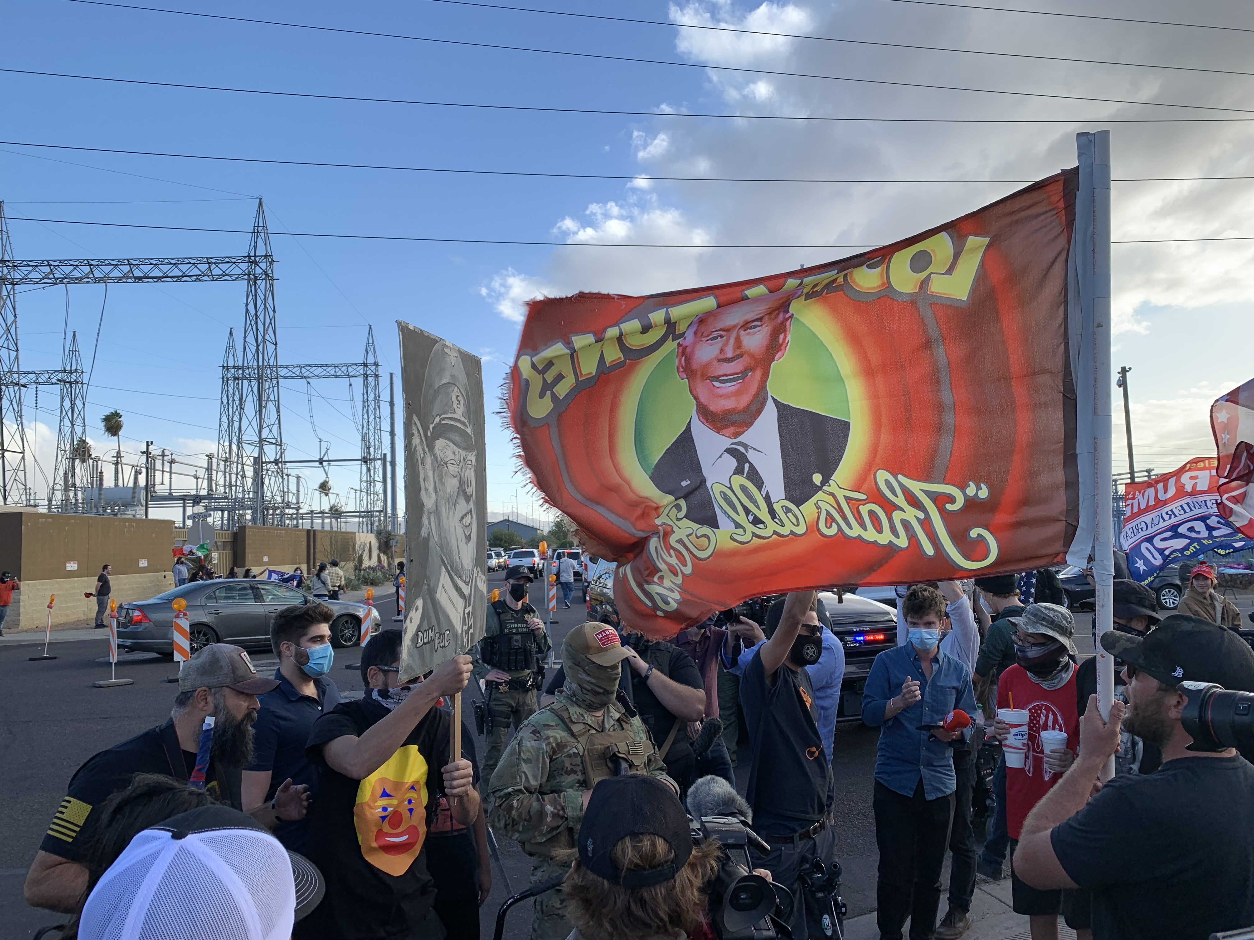 Many in the pro-Trump crowd in Phoenix, Arizona carried rifles or had firearms holstered on their sides and taunted local media crews [Patrick Strickland/Al Jazeera]
