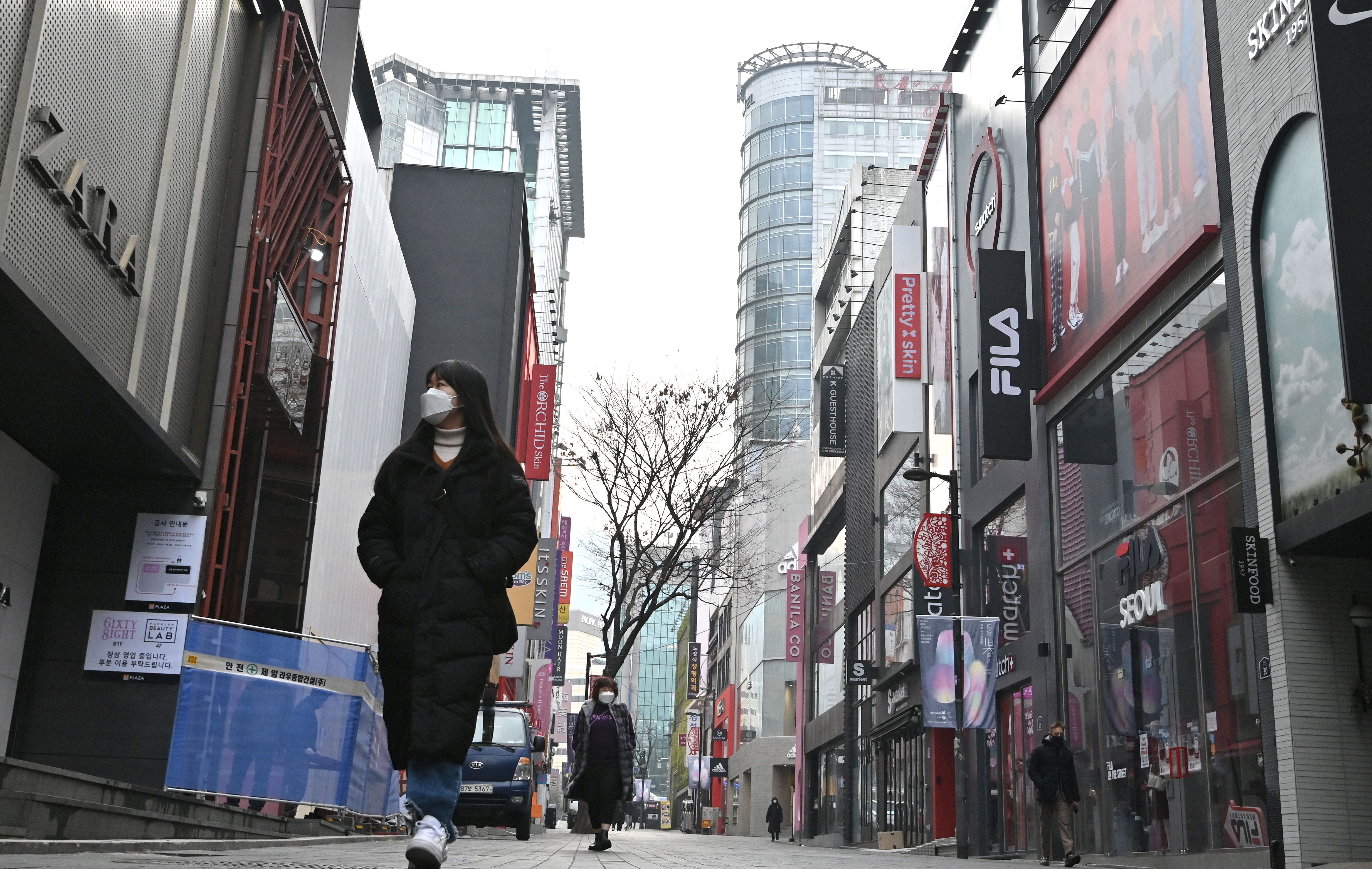 A woman walking on a street in Seoul, South Korea