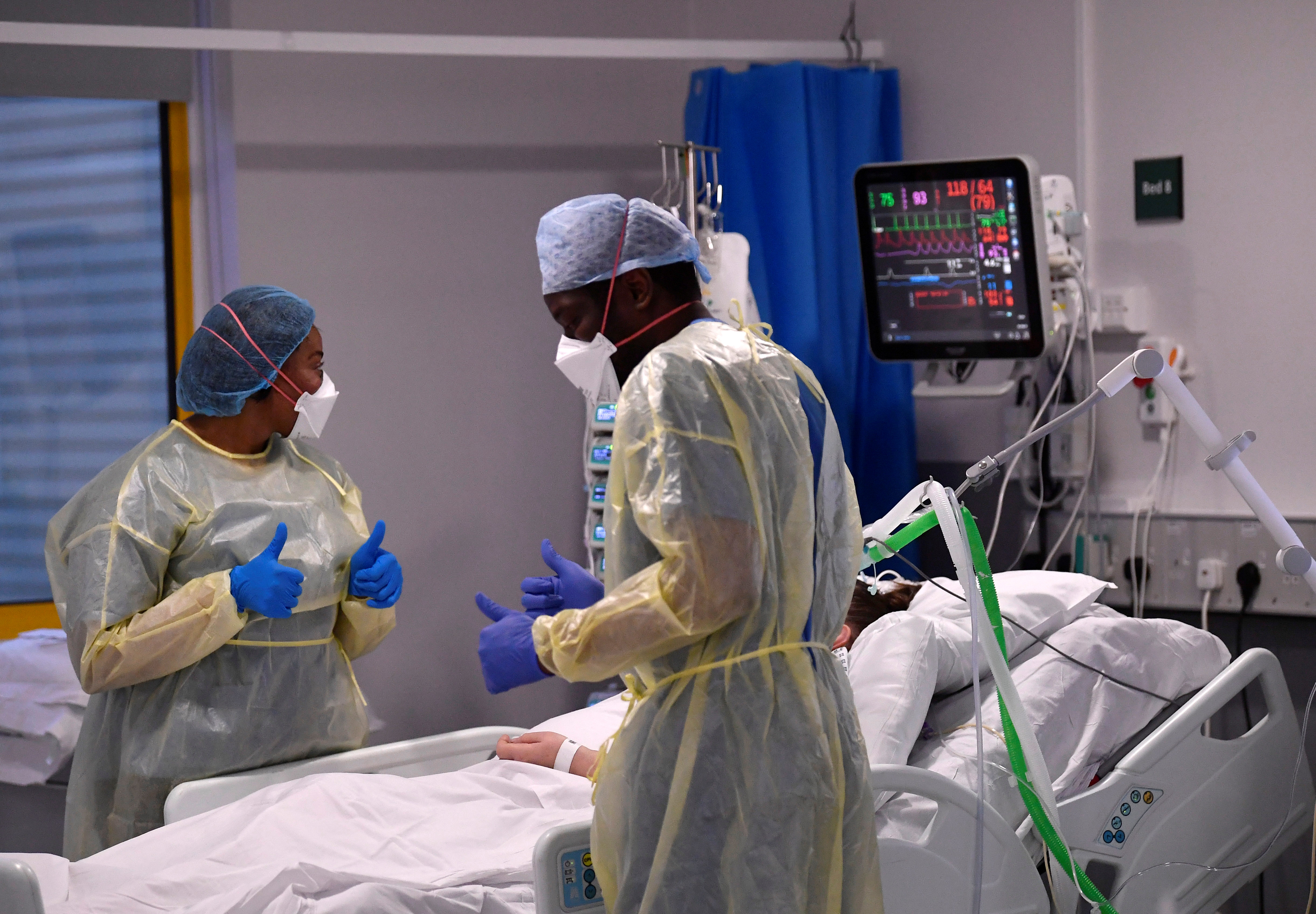Nurses react as they treat a COVID-19 patient in the ICU (Intensive Care Unit) at Milton Keynes University Hospital, amid the spread of the coronavirus disease (COVID-19) pandemic, Milton Keynes, Britain, January 20, 2021 [Toby Melville/Reuters]