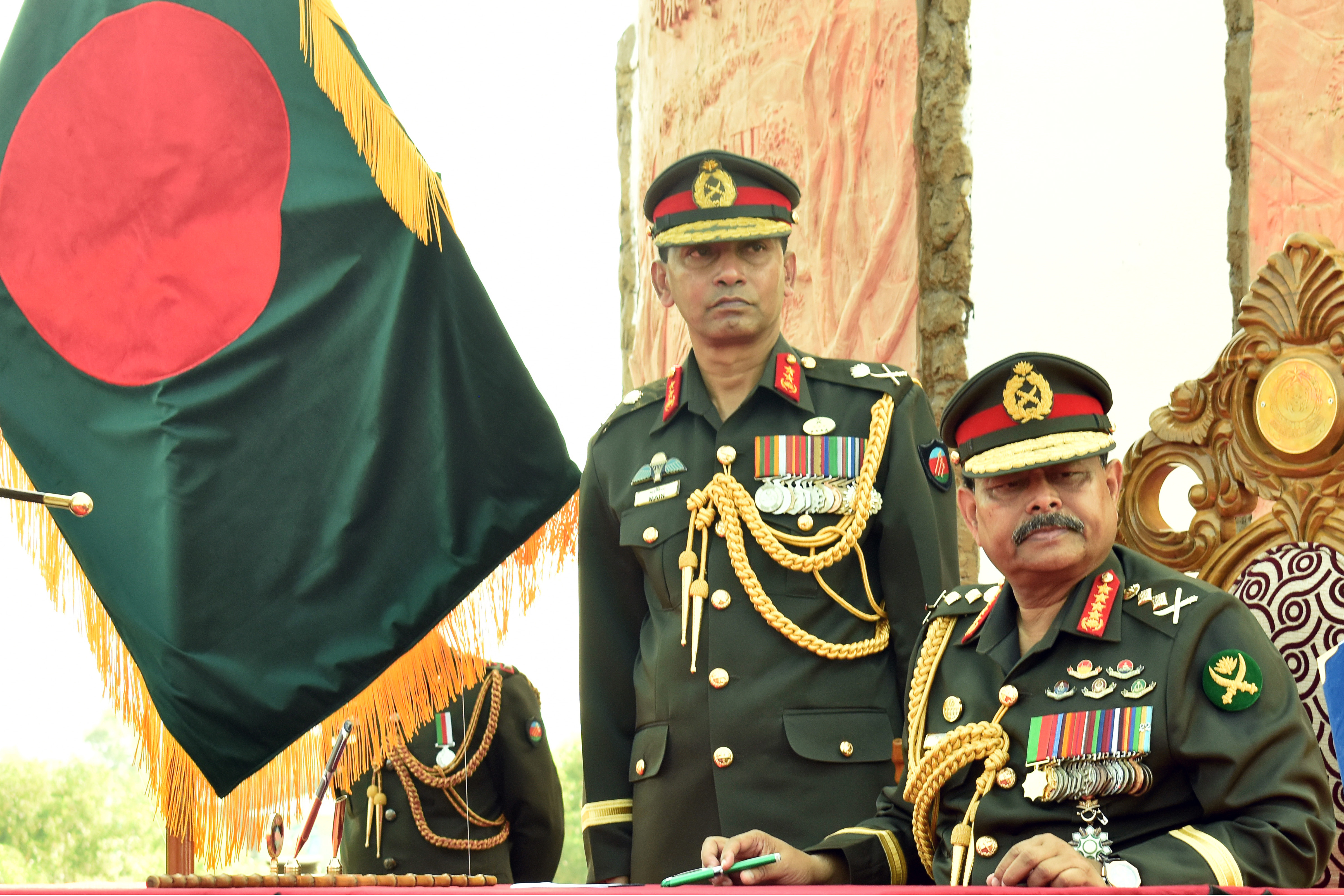 Army chief General Aziz Ahmed (R) looks on during a program in a refugee camp in Ukhia on November 24, 2019. - Bangladesh has started implementing erection of barbed-wire fencing around the southeastern Rohingya camps, the country's army chief said on November 24 amid growing concerns among the refugees. (Photo by STR / AFP)