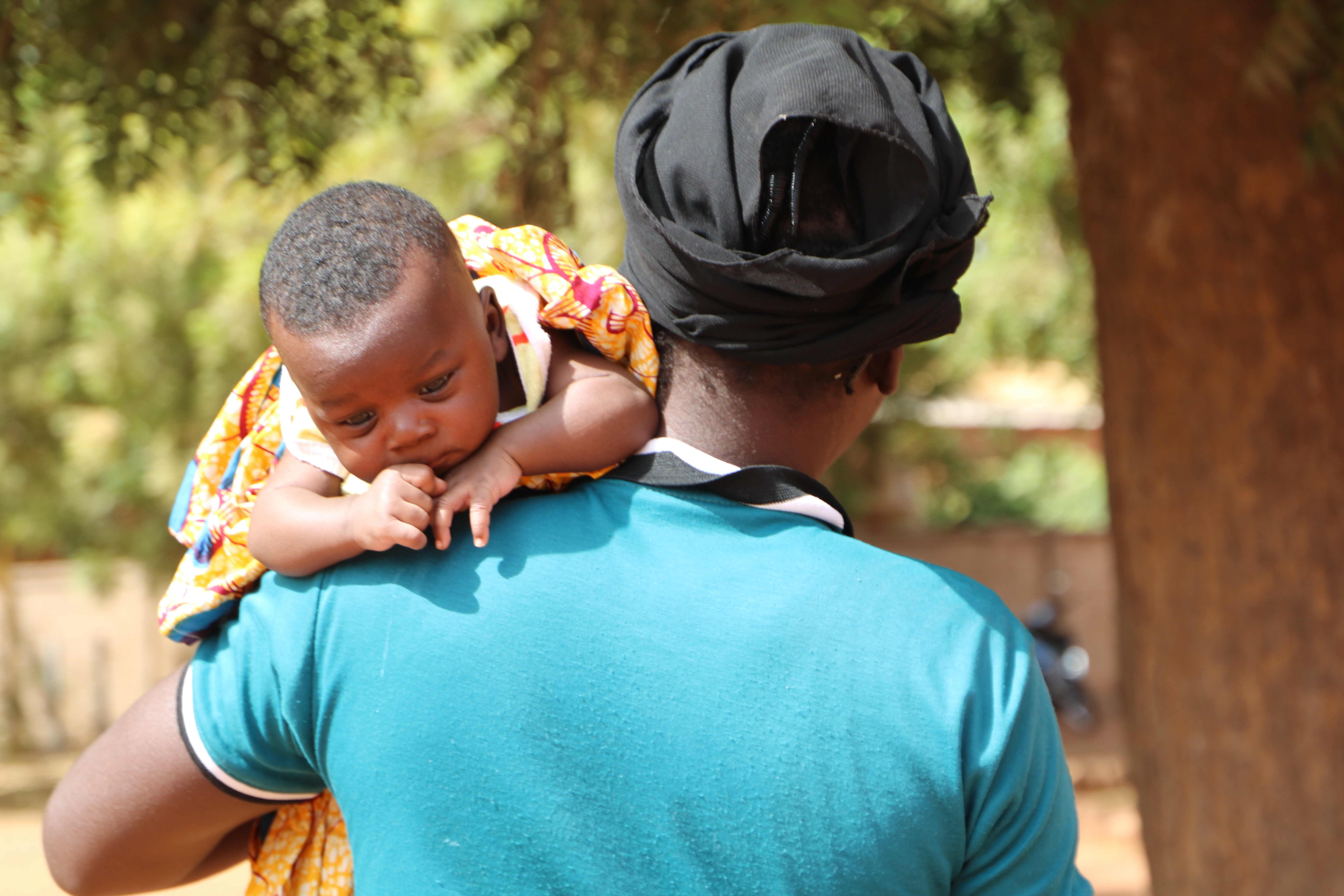 Pauline waits at an orphanage in Yako where she will leave her baby son [Sam Mednick/Al Jazeera]