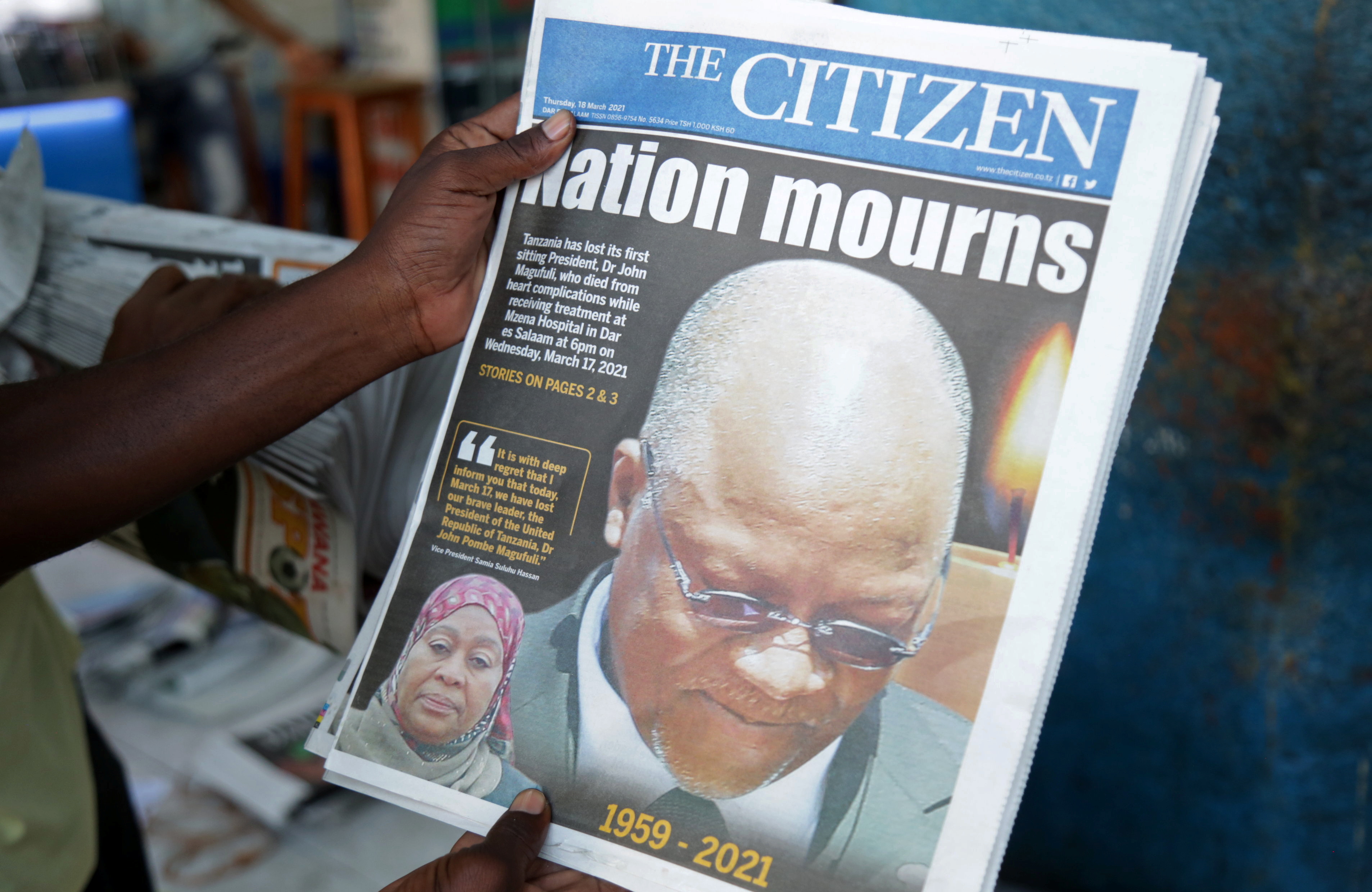 A man holds a newspapers following the death of Tanzania's President John Magufuli [Emmanuel Herman/Reuters]
