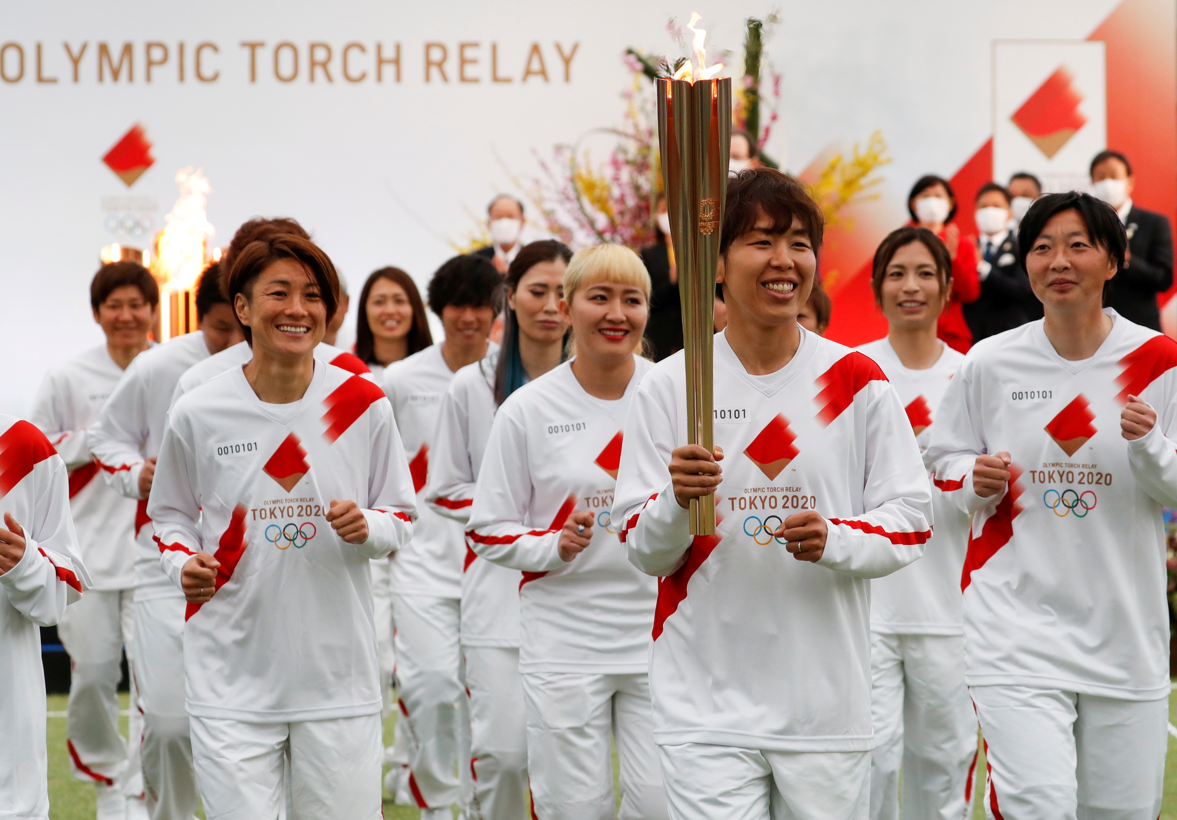 Some 10,000 runners will now carry the flame across Japan’s 47 prefectures over the next 121 days [Kim Kyung-Hoon/Pool via Reuters]