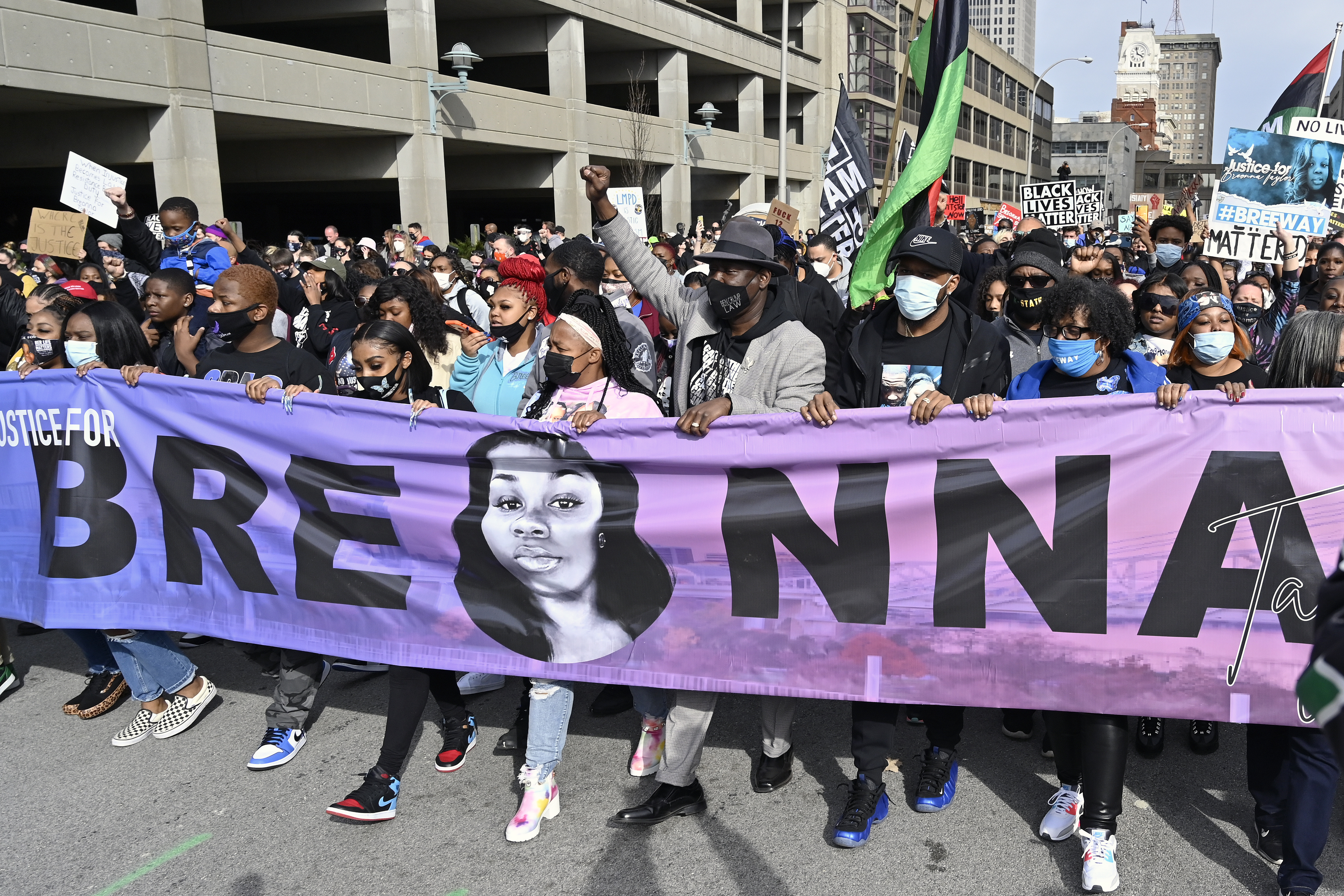 Tamika Palmer, center, the mother of Breonna Taylor, leads a march through the streets of downtown Louisville on the one year anniversary of her death.
