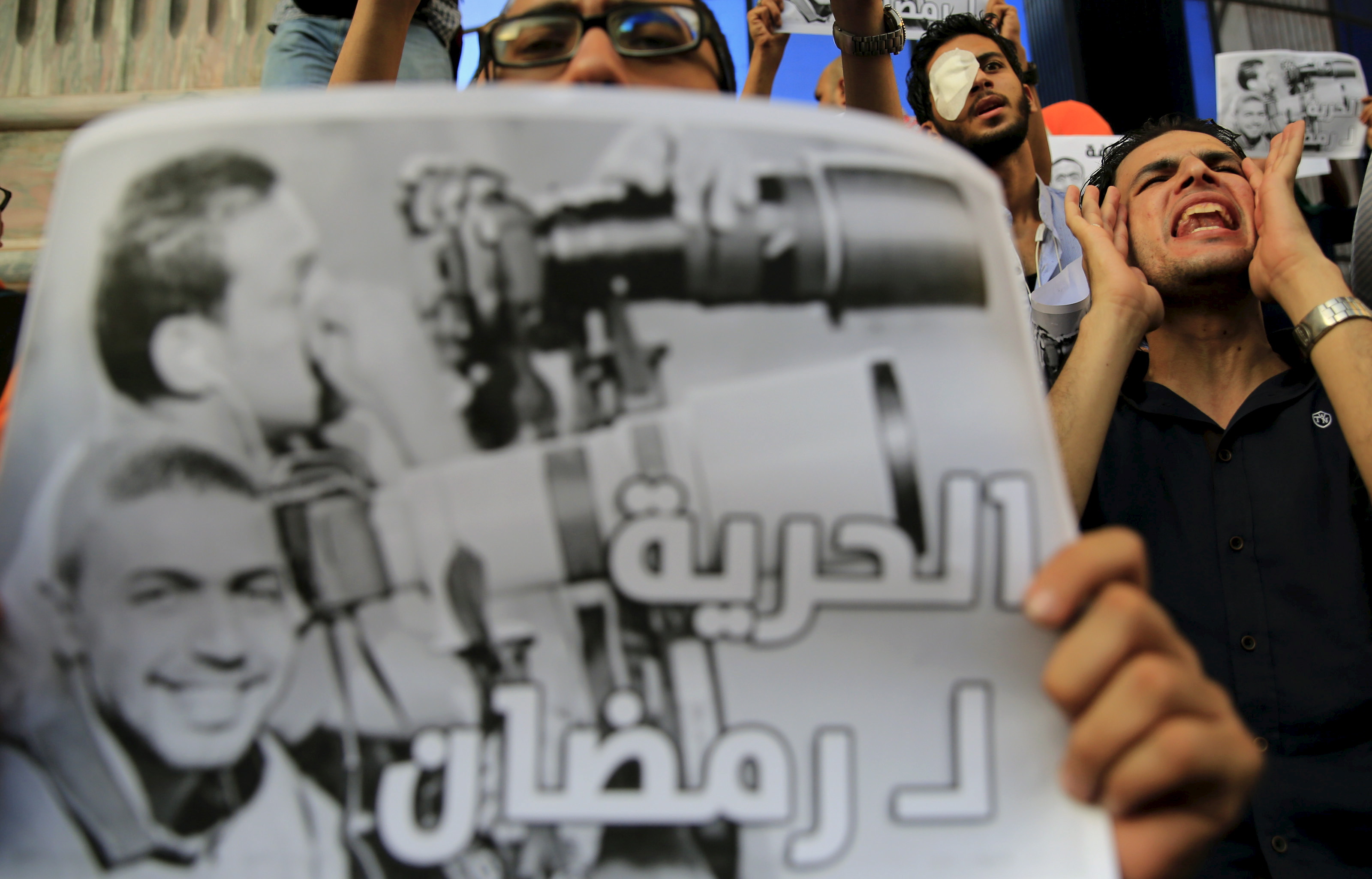 Journalists take part in a protest against the detention of Ahmed Ramadan, a photojournalist with Egyptian private newspaper "Tahrir", in front of the Syndicate of Journalists in Cairo, Egypt on August 17, 2015 [Amr Abdallah Dalsh/Reuters]