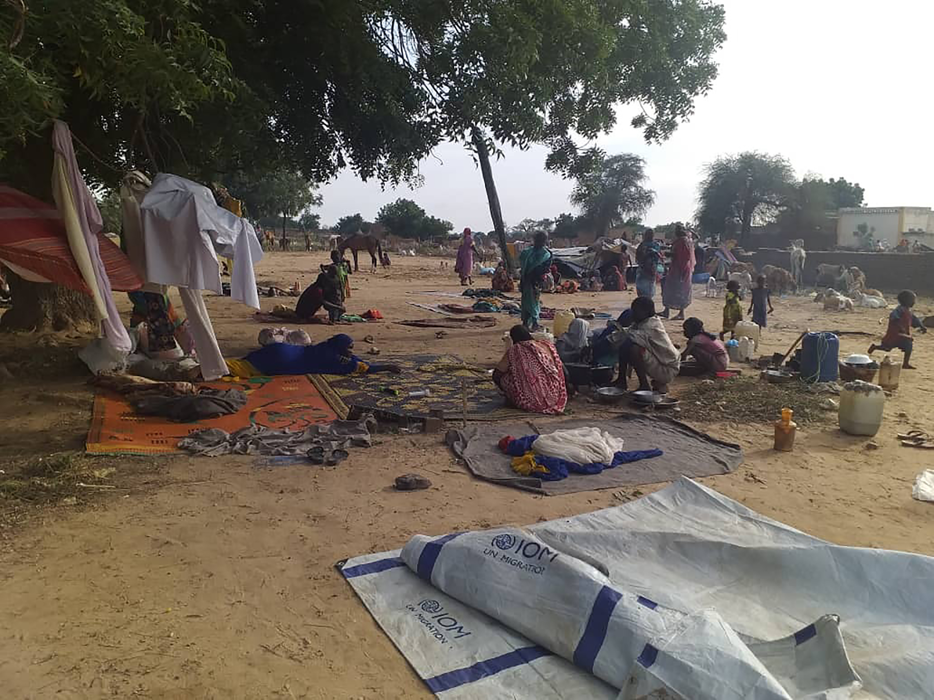 residents displaced from a surge of violent attacks squat on blankets and in hastily made tents in the village of Masteri in west Darfur, Sudan.