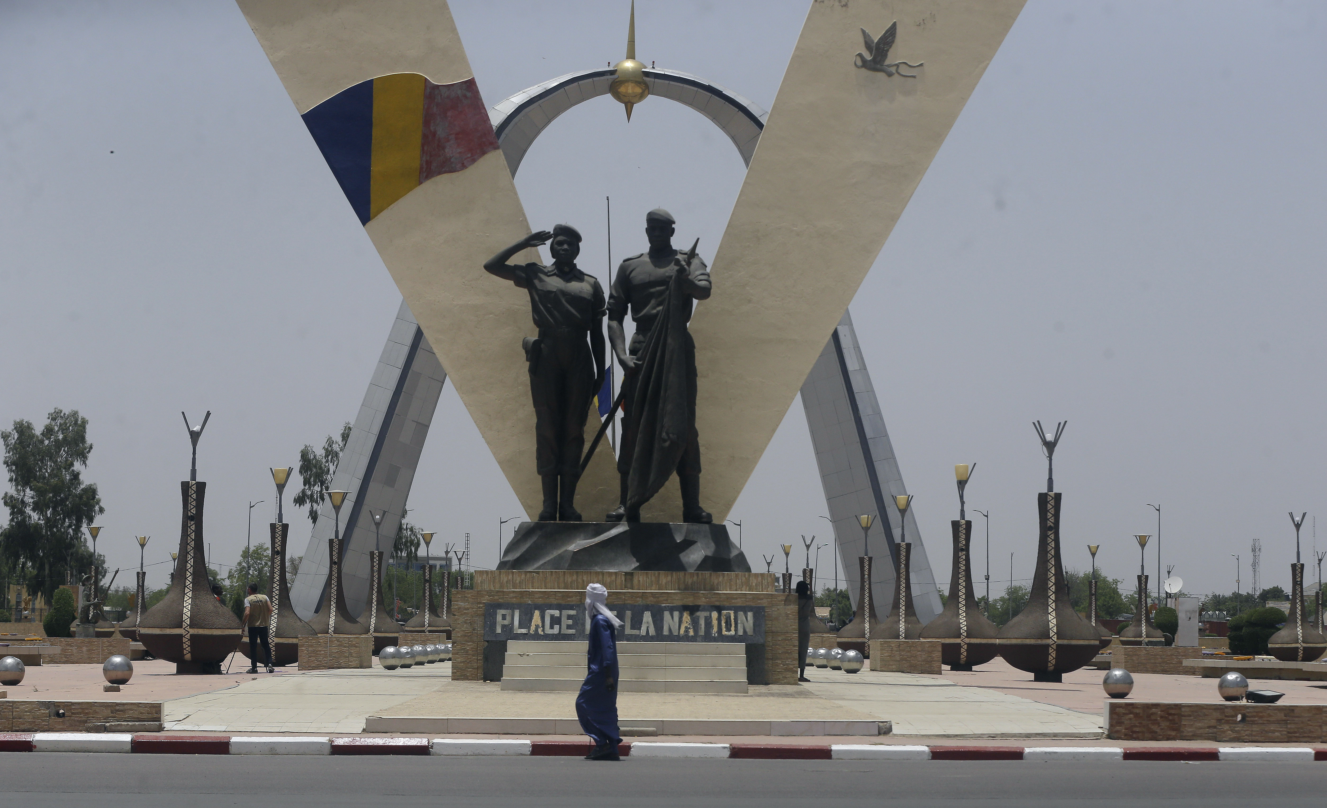 A man walks past "Place de Le Nation" (Monument of independence) park in N'Djamena, Chad, Monday, April 26, 2021. Chad's military transitional government said Sunday it will not negotiate with the rebels blamed for killing the country's president of three decades, raising the specter that the armed fighters might press ahead with their threats to attack the capital.
