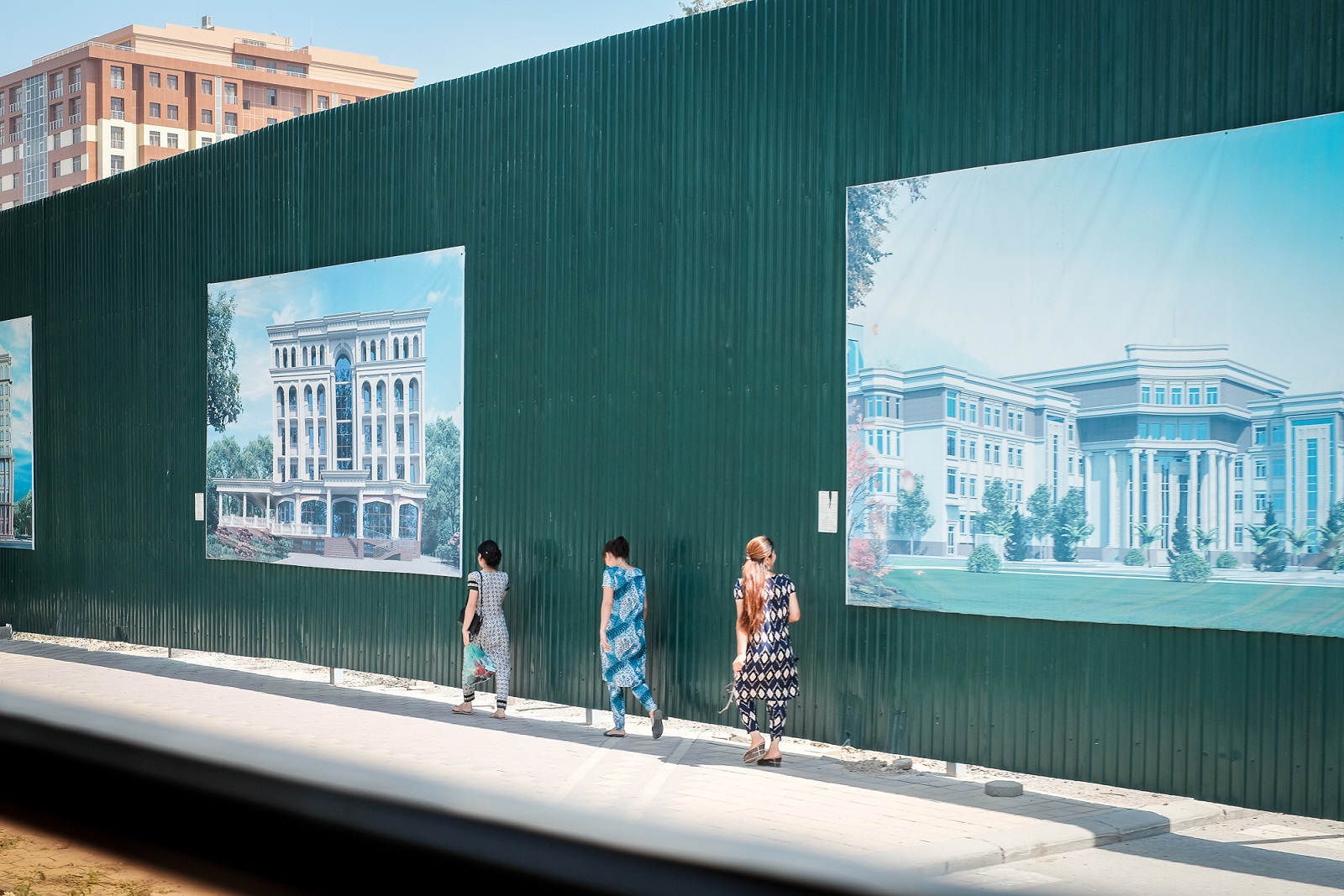 Dushanbe's residents have become accustomed to the ubiqutous construction site fencing covered in images of the imagined future of their city [Tahmina Inoyatova/Al Jazeera]