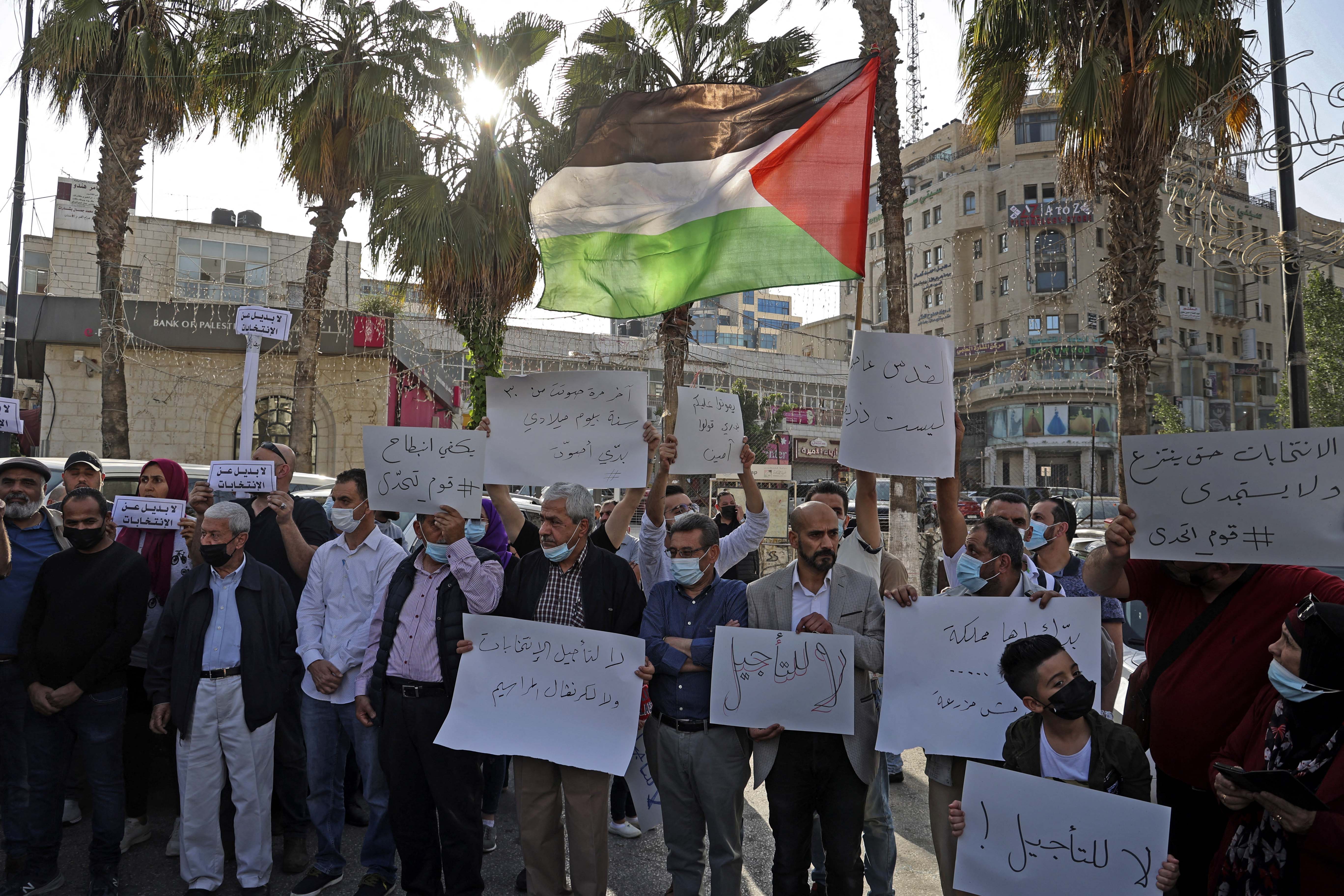 Palestinians demonstrate in the centre of the city of Ramallah in the occupied West Bank on April 28, 2021 against any postponement of the Palestinian parliamentary and presidential elections [AFP/Abbas Momani]