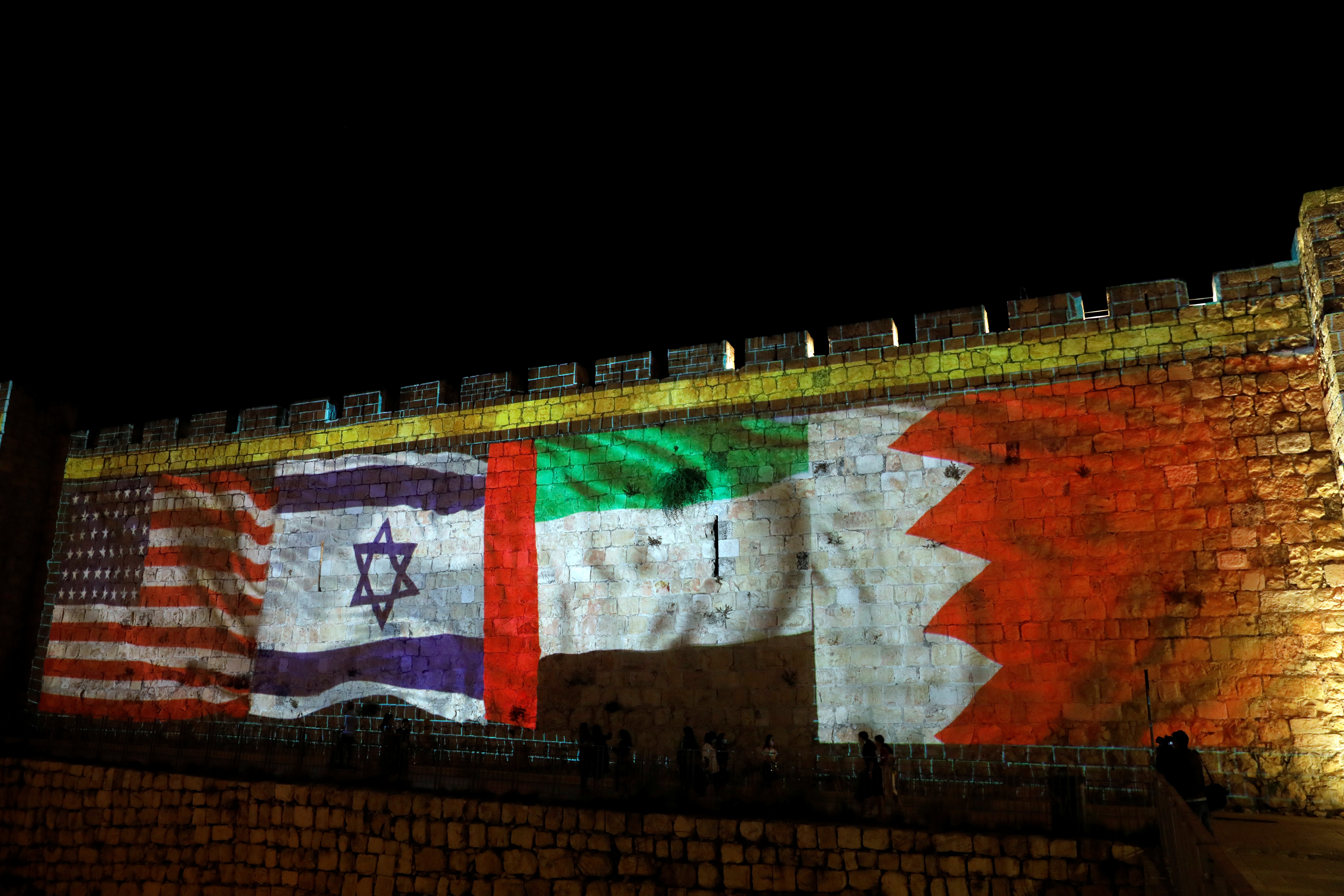The national flags of the United States, Israel, the United Arab Emirates and Bahrain are projected on the walls of Jerusalem's Old City [File: Ronen Zvulun/Reuters]