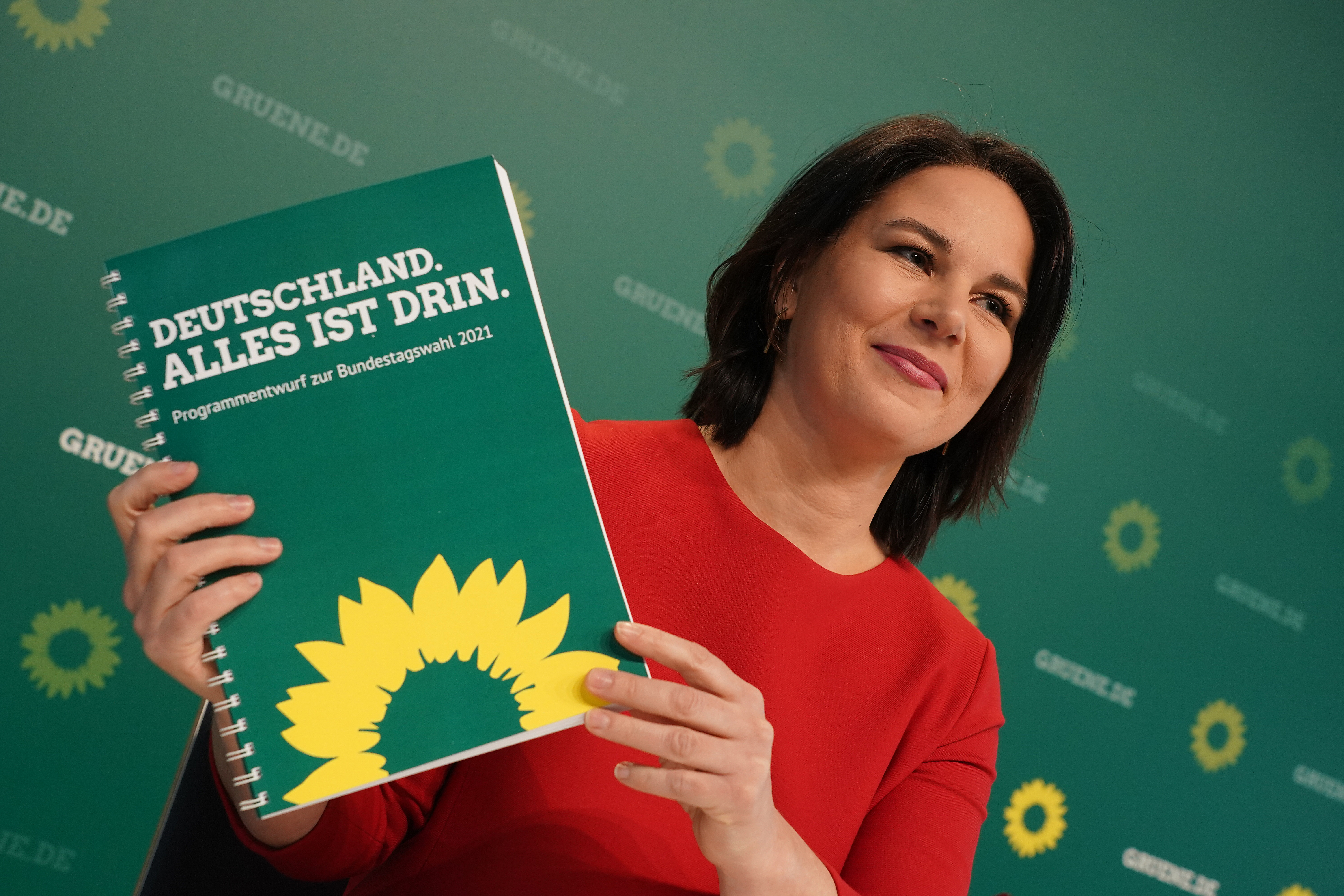 Annalene Baerbock, co-leader of the German Greens Party, holds up a description of the party's policy program at a livestreamed, digital press conference ahead of Germany's federal elections scheduled for September on March 19, 2021 in Berlin, Germany [Sean Gallup/Getty Images]