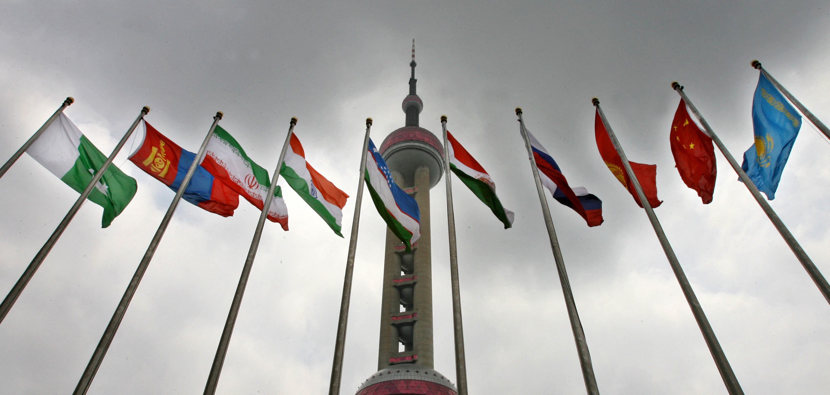 Flags of various countries flying together.
