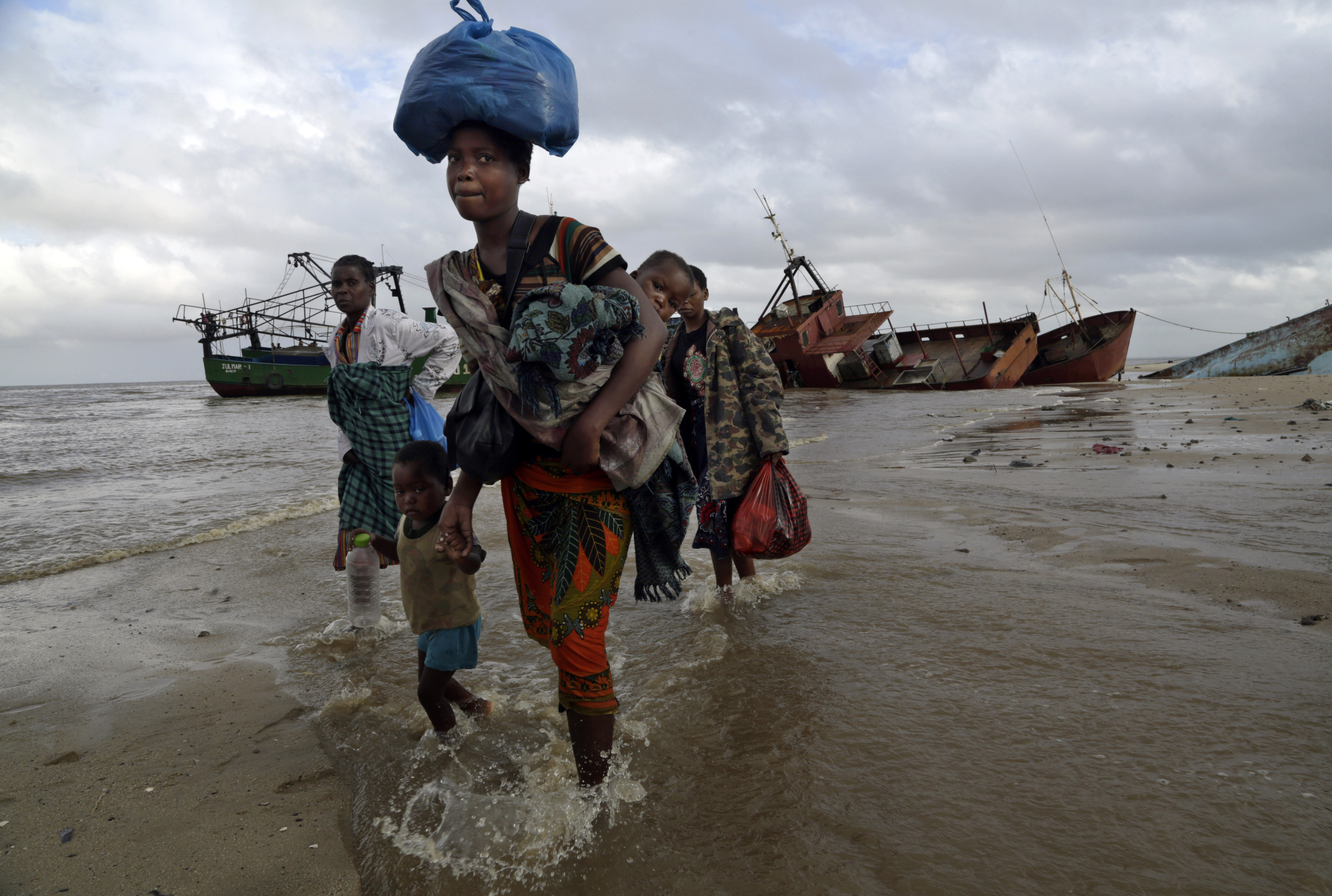 In a photo from March 23, 2019, displaced families arrive after being rescued by boat from a flooded area of Buzi district, Mozambique, in the aftermath of Cyclone Idai [File: Tsvangirayi Mukwazhi/AP Photo]
