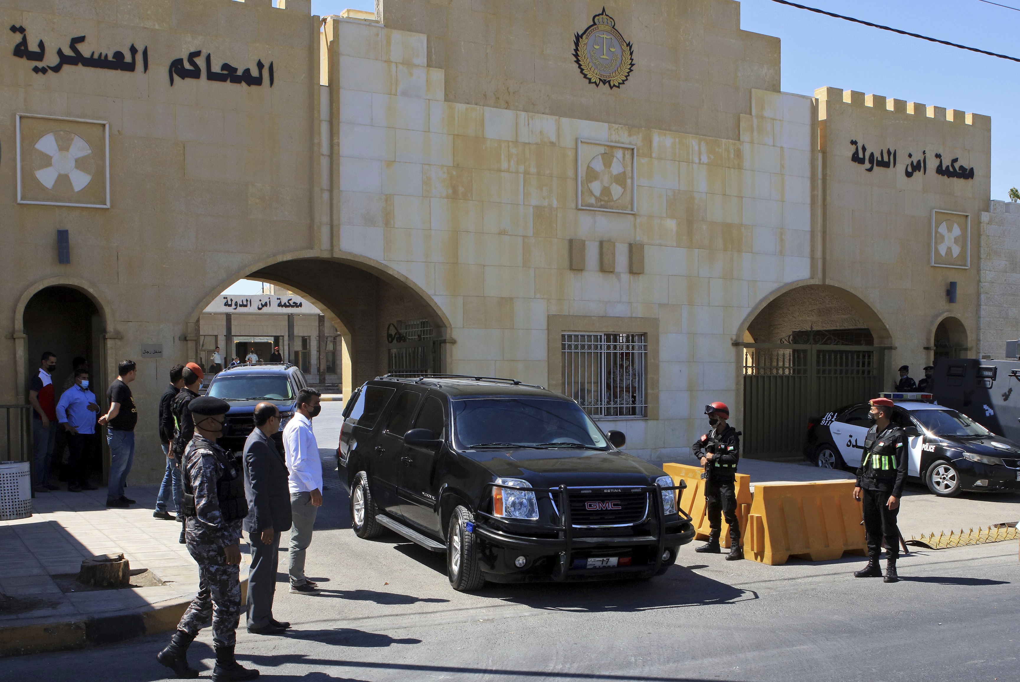 Bassem Awadallah, a former royal adviser, leaves a state security court in a vehicle after the first session of his trial, in Amman, Jordan [Raad Adayleh/AP Photo]