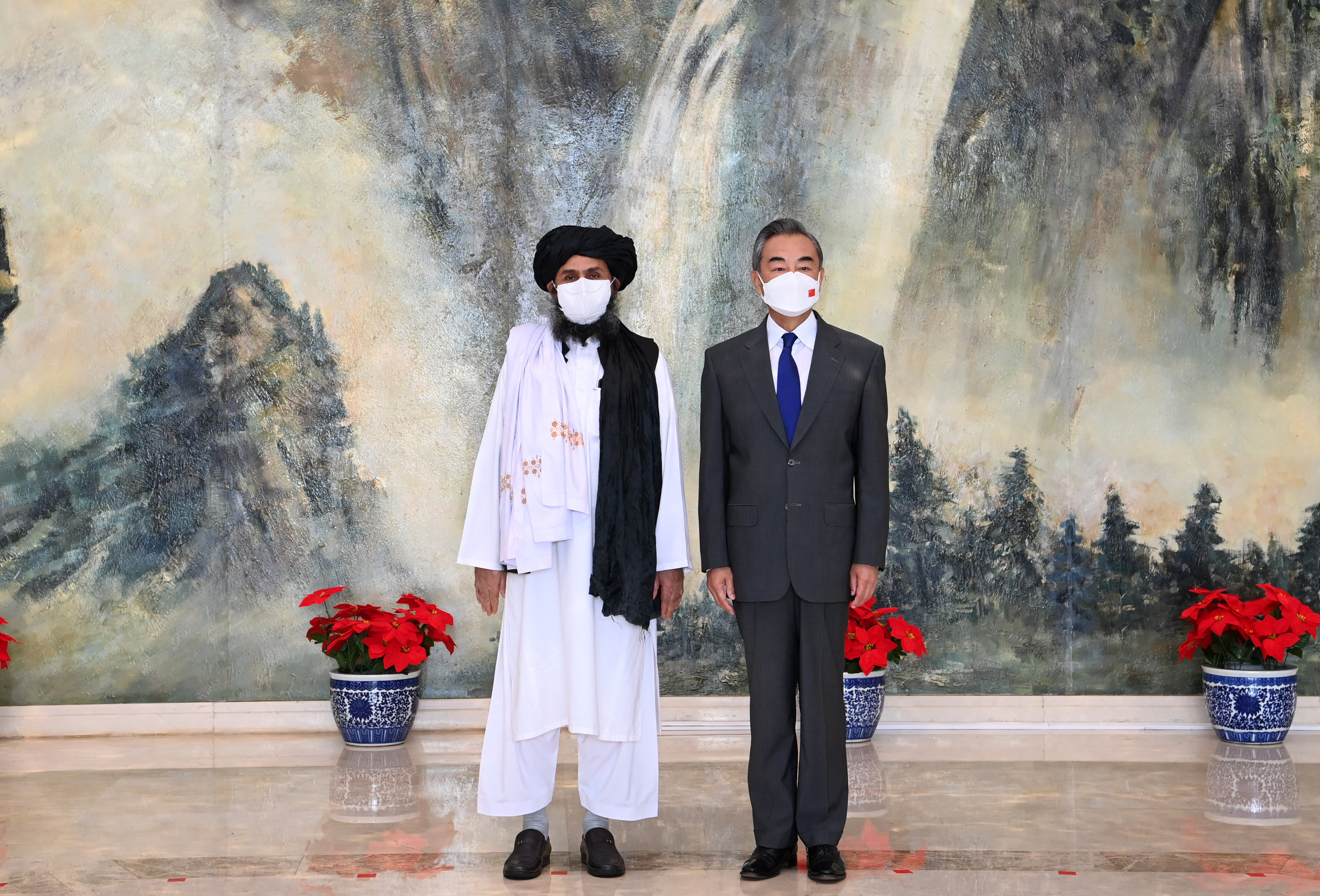 Meetings between Chinese State Councilor and Foreign Minister Wang Yi (right) and Taliban leadership including political chief Mullah Abdul Ghani Baradar (left) in China last month were important for laying the groundwork for further communication between the two parties [File: Li Ran/Xinhua/AFP]