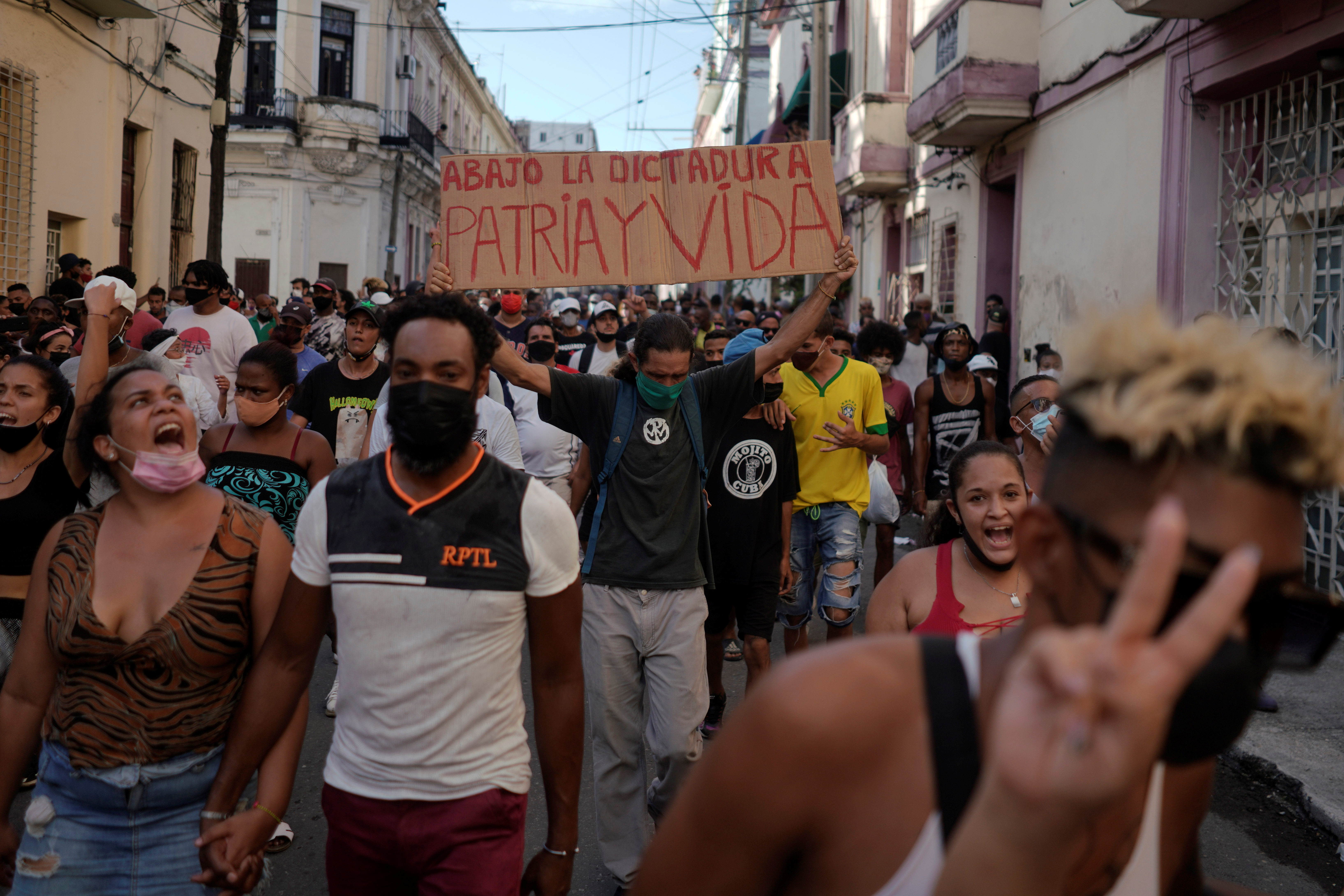 People shout slogans against the government in Havana, Cuba on July 11 [Alexandre Meneghini/Reuters]