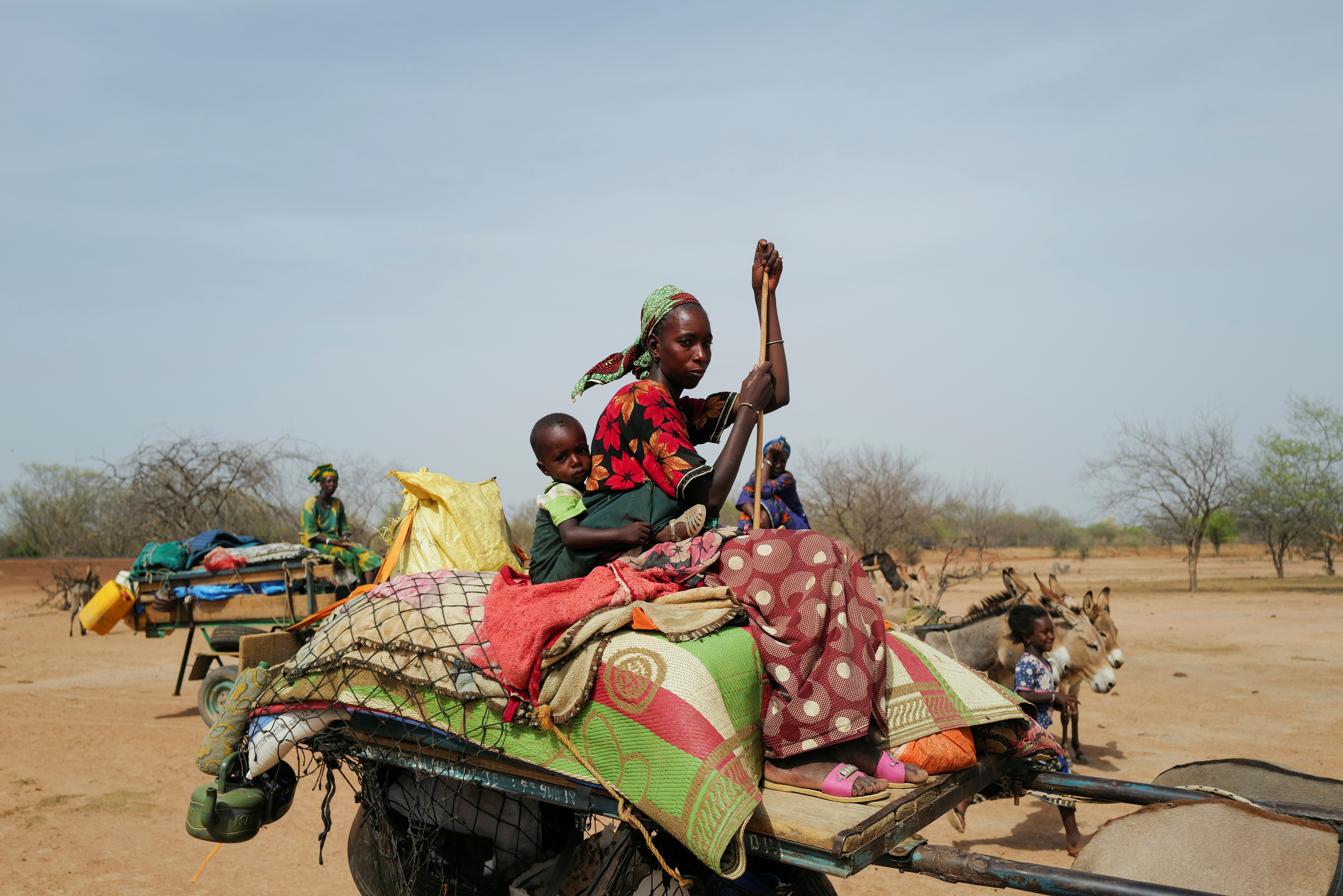 A Fulani nomadic tribe member sits on a cart as she travels in the Barkedji-Dodji Forest, in Linguere department, Louga region, Senegal, July 14, 2021