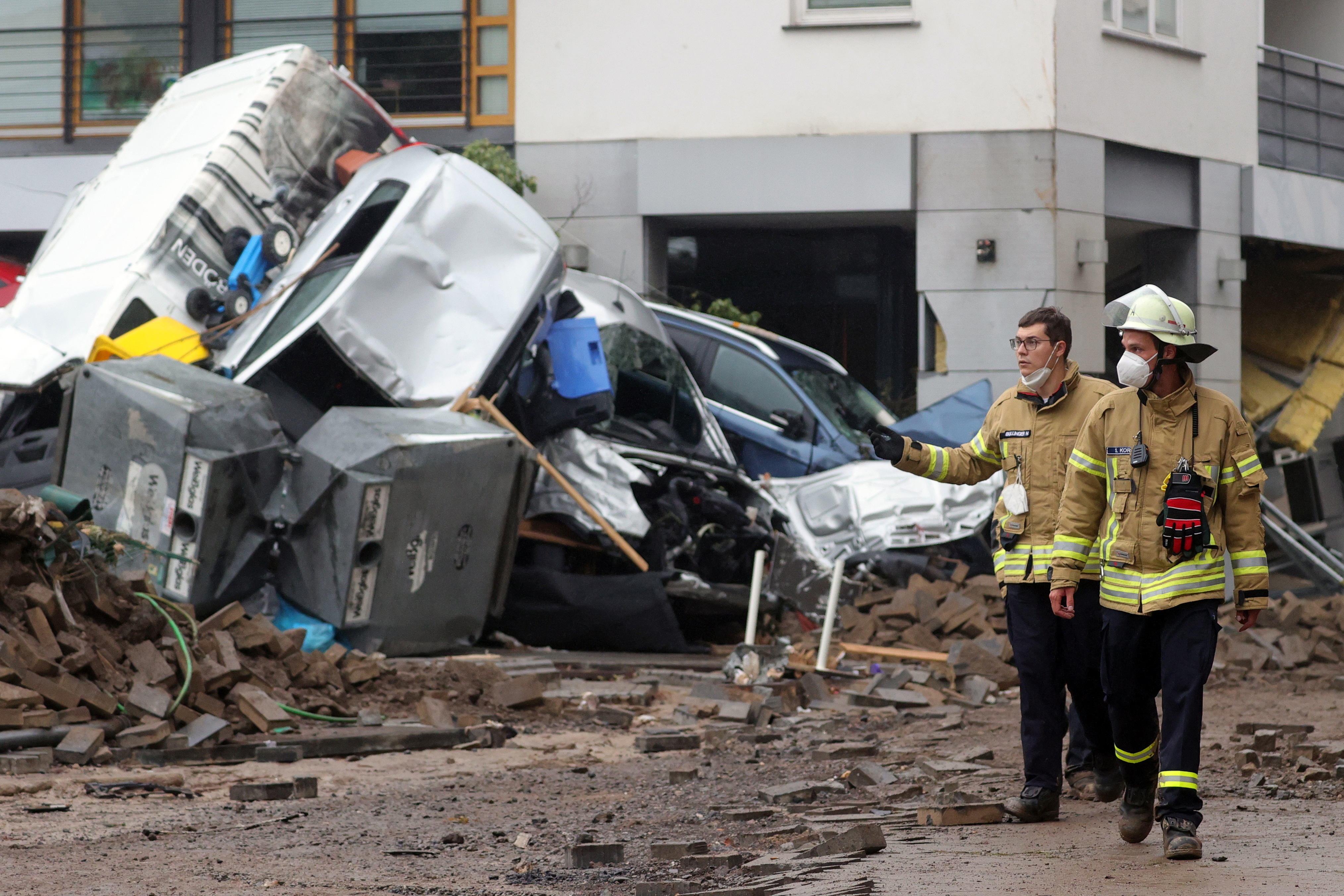 Members of the fire department (Feuerwehr) inspect a damaged area after flooding in Bad Neuenahr-Ahrweiler, Germany, 16 July 2021.