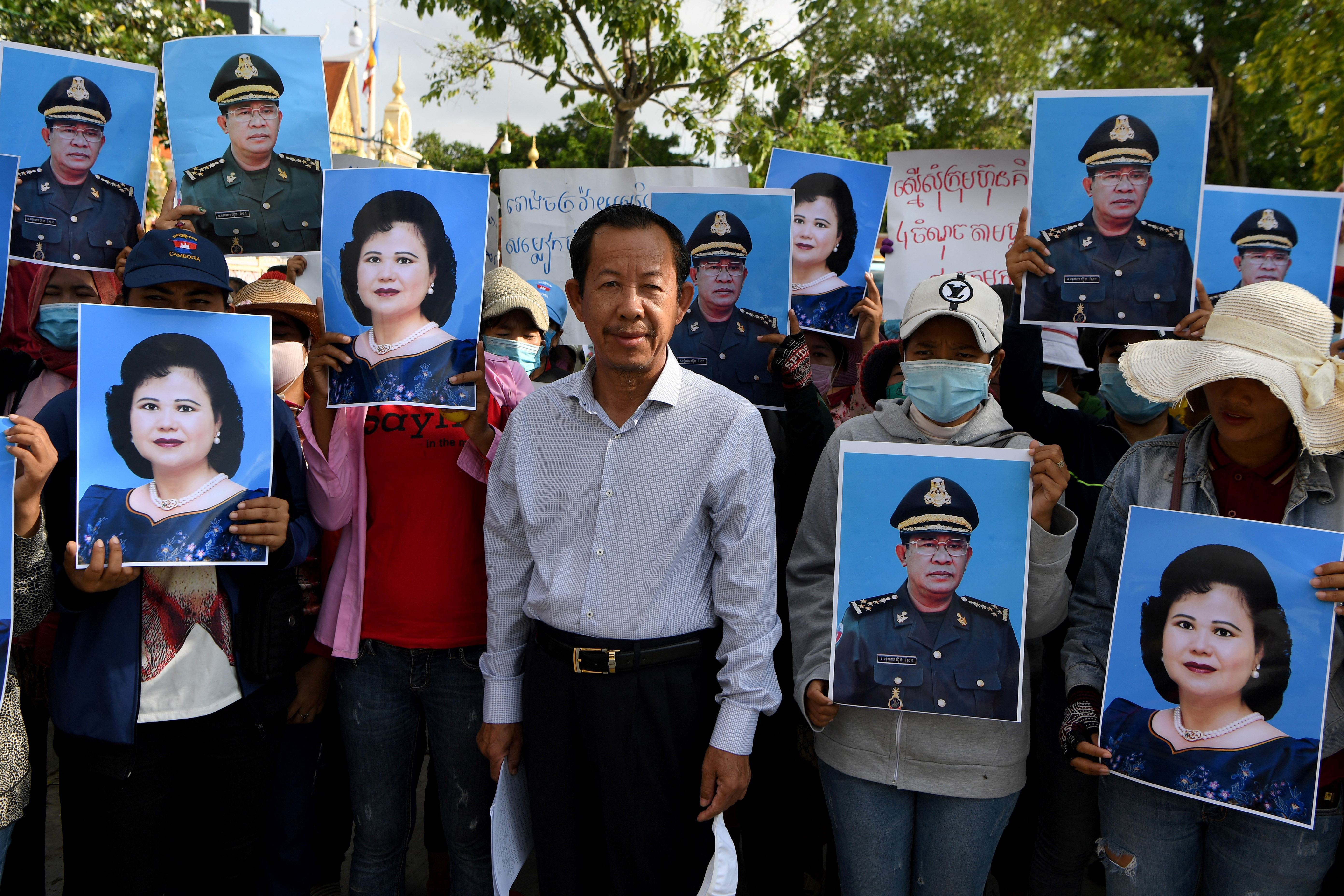 Rong Chhun, centre, one of Cambodia's most prominent union leaders is facing a court verdict on Wednesday [File: Tang Chhin Sothy/AFP]