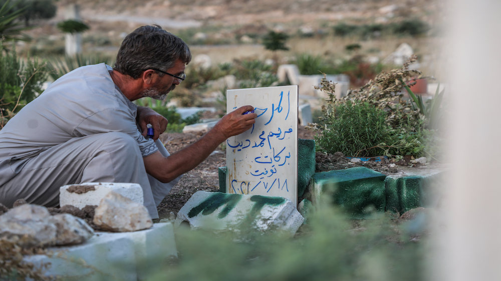 Muhammad Barakat visits the grave of his daughter, Maryam, in Jabal al-Zawiya in Idlib [Mohamad Daboul/Al Jazeera]