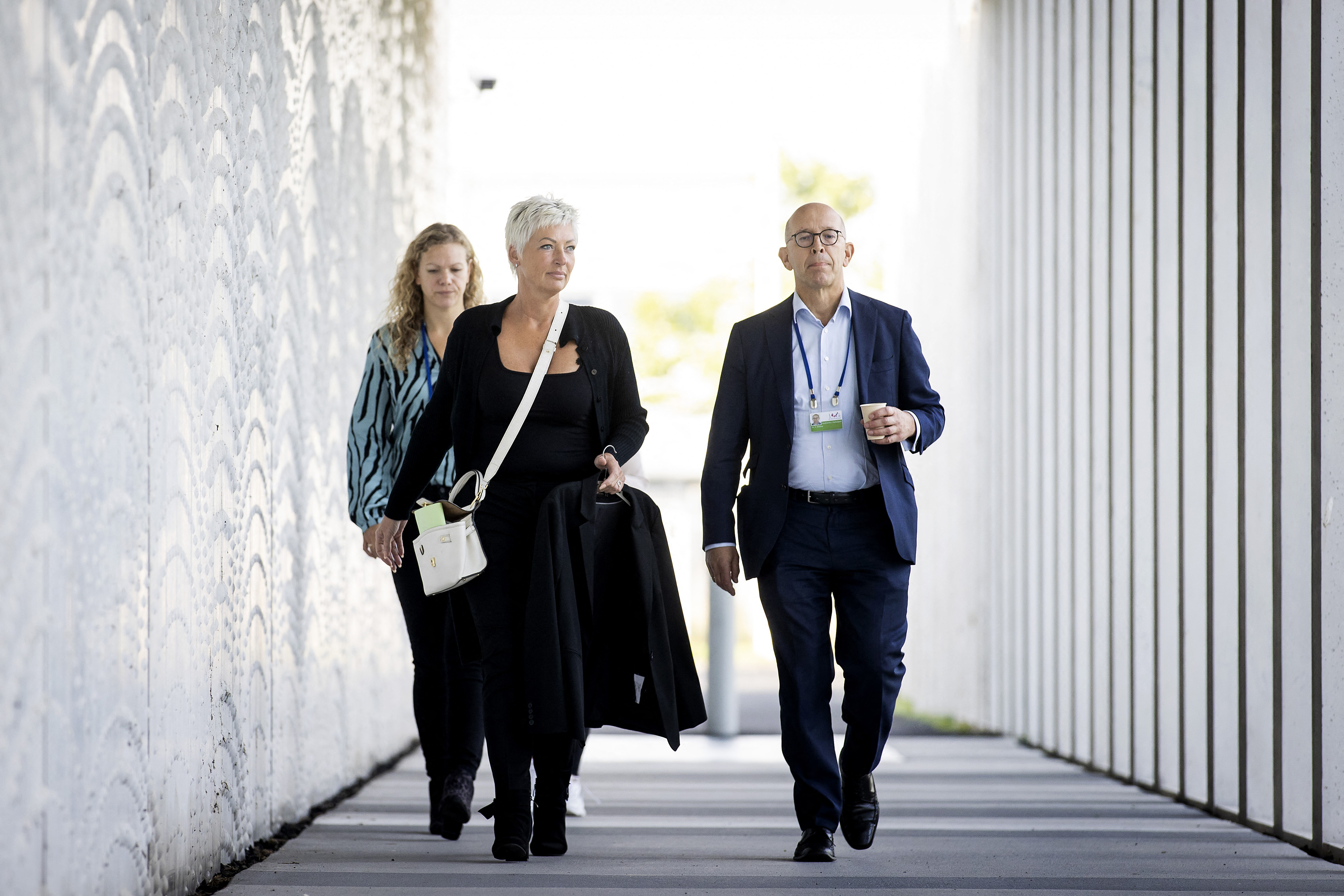 Spokesperson for victims' relatives Ria van der Steen, centre, arrives at the Schiphol Judicial Complex in Badhoevedorp [Koen van Weel/ ANP via AFP]