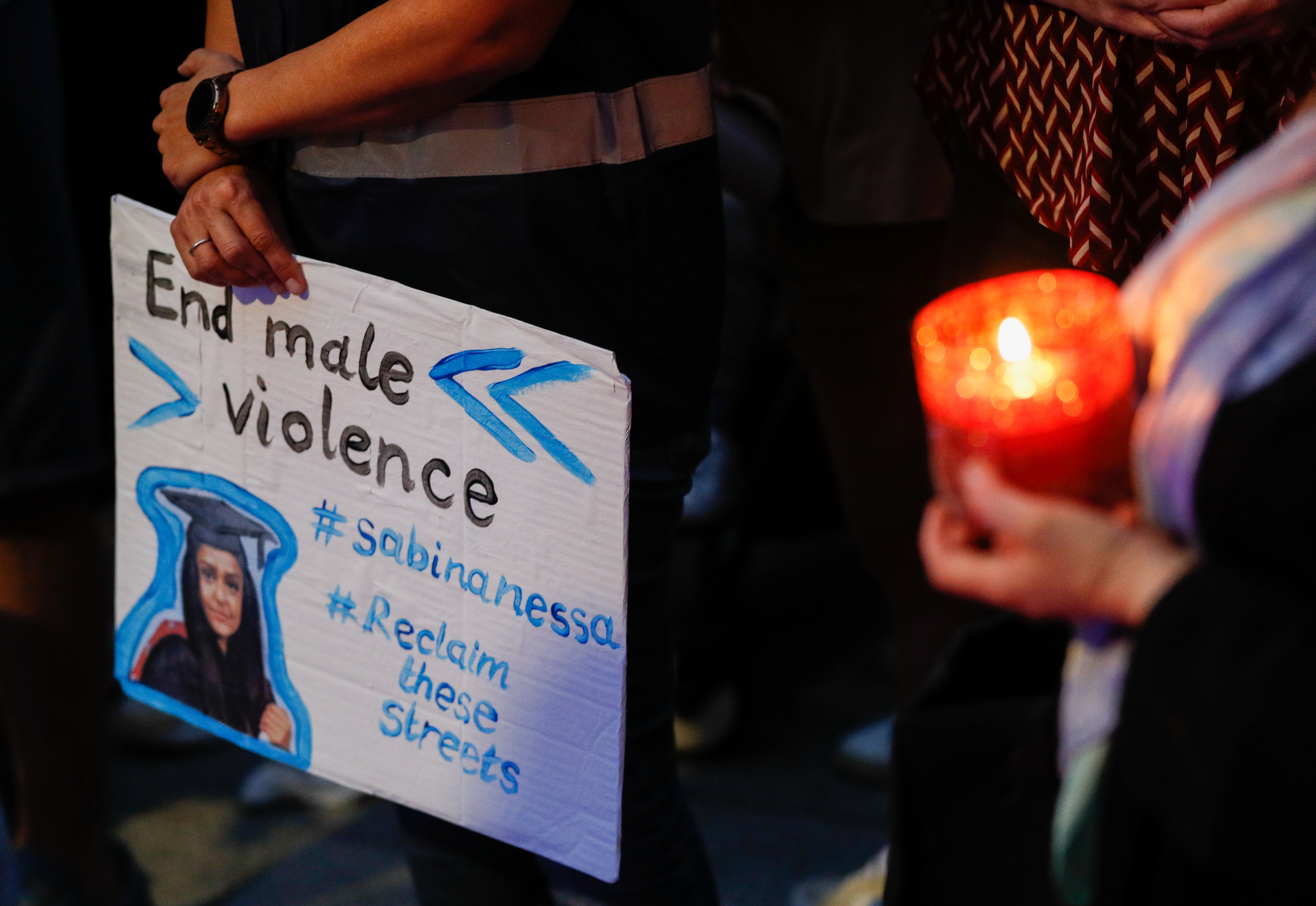 A person holds a placard during a vigil in memory of Sabina Nessa, a teacher who was murdered in Pegler Square, in London on September 24, 2021 [Reuters/Peter Nicholls]