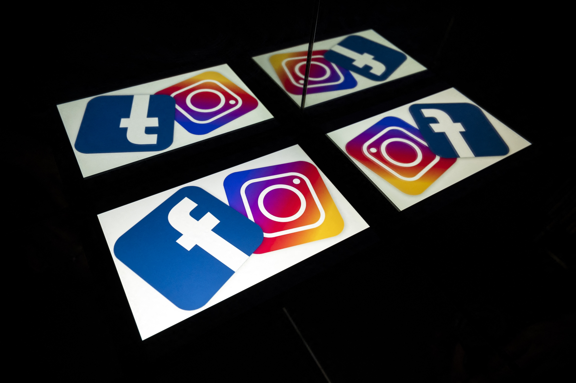 (FILES) this file photo taken on October 05, 2020 in Toulouse, southwestern France, shows logos of US social networks Facebook and Instagram on the screens of a tablet and a mobile phone. - Major social media services including Facebook, Instagram and WhatsApp were hit by a massive outage on October 4, 2021, tracking sites showed, impacting potentially tens of millions of users. (Photo by Lionel BONAVENTURE / AFP)