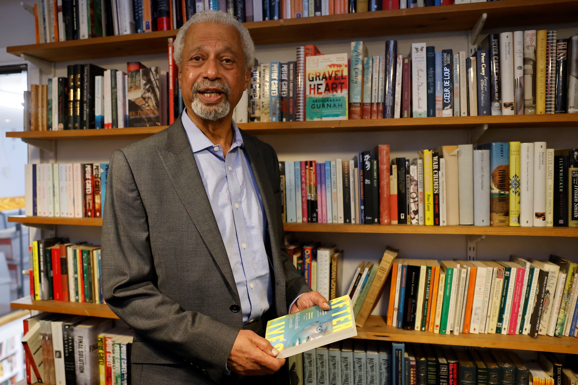 Zanzibar-born author Abdulrazak Gurnah poses for a photo call prior to attending a press conference, after he was awarded the Nobel Prize for literature, in London on October 8, 2021 [Tolga Akmen / AFP]