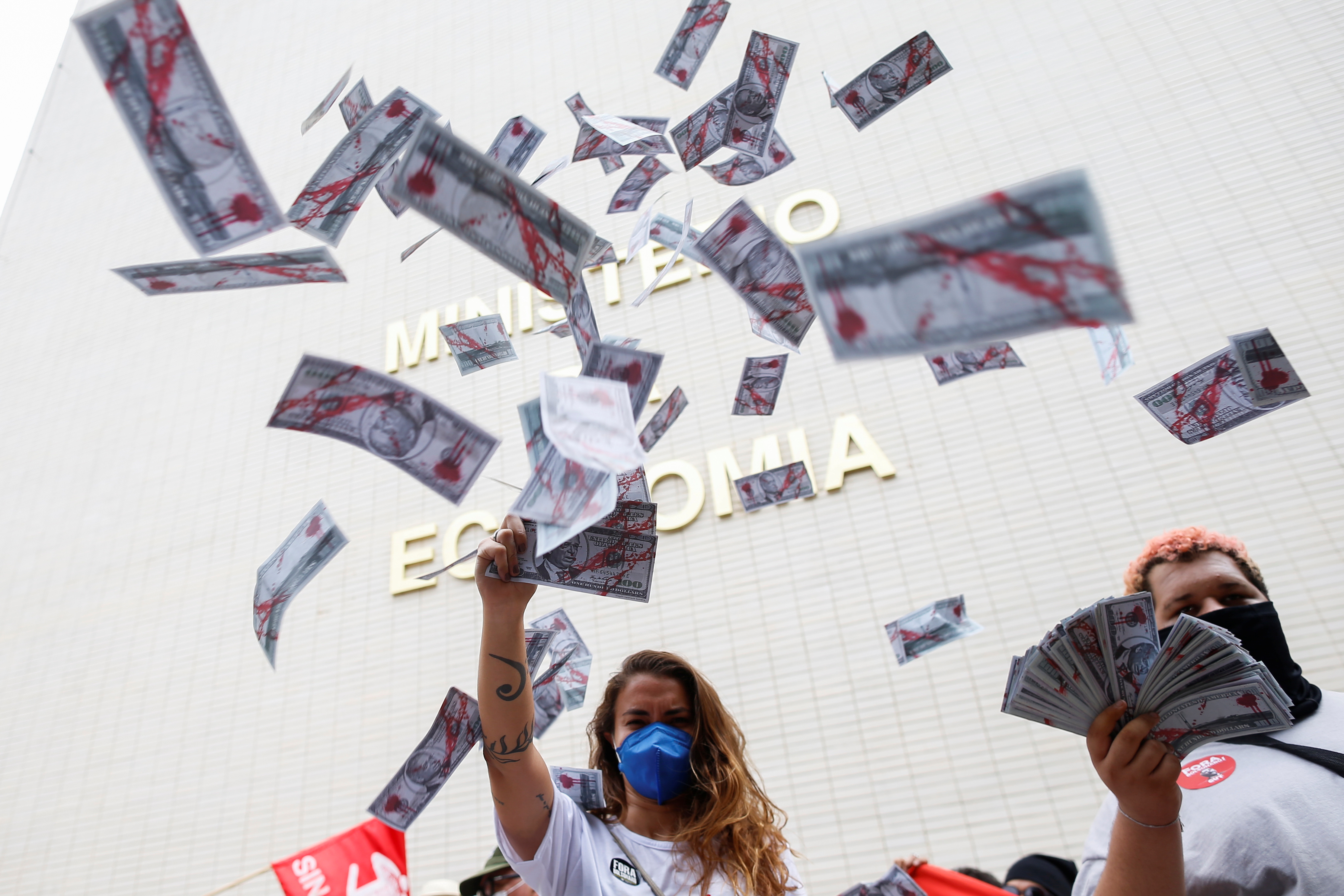 Demonstrators take part in a protest against Brazil's Economy Minister Paulo Guedes after revelations in the Pandora Papers about his offshore bank accounts, in Brasilia on October 7, 2021 [Reuters/Adriano Machado]