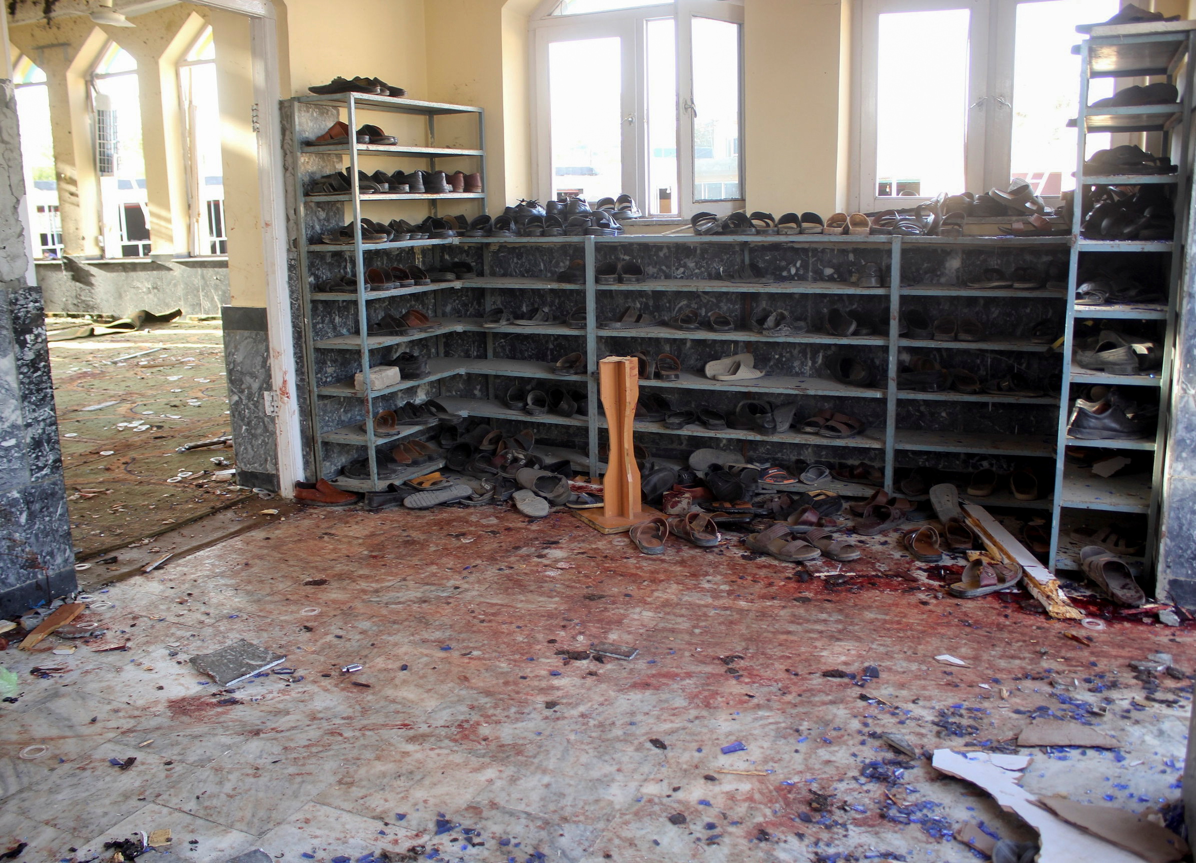 Shoes and bloodstains are seen inside a mosque after a blast in Kunduz, Afghanistan [Reuters]