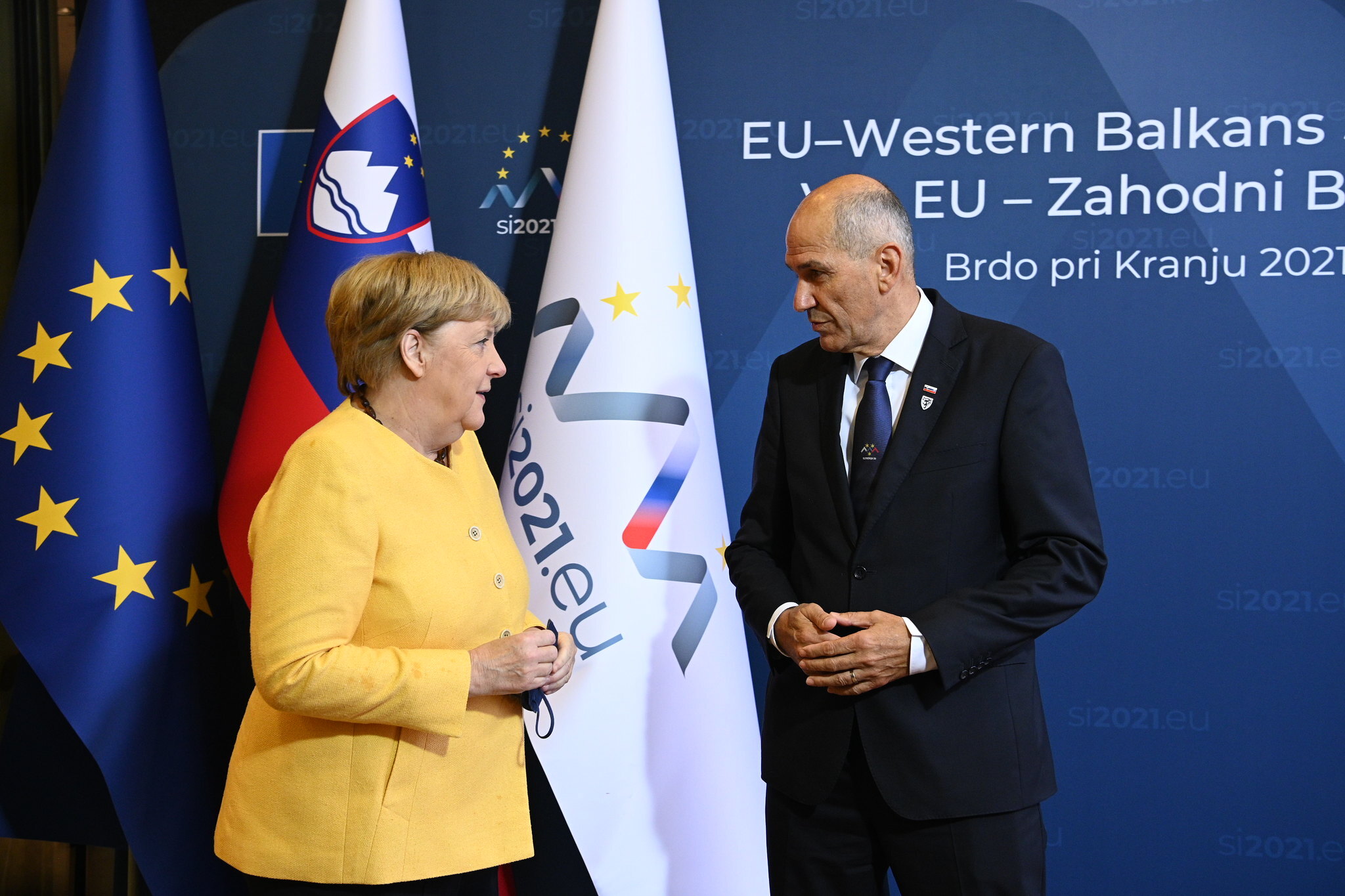 Slovenia's Prime Minister Janez Jansa (R) welcomes Germany's Chancellor Angela Merkel (L) for the EU-Western Balkans summit at Brdo Congress Centre, in Brdo pri Kranju, in Kranj, Slovenia, on October 6, 2021. [Photo by Government of Slovenia/Handout via Getty Images]