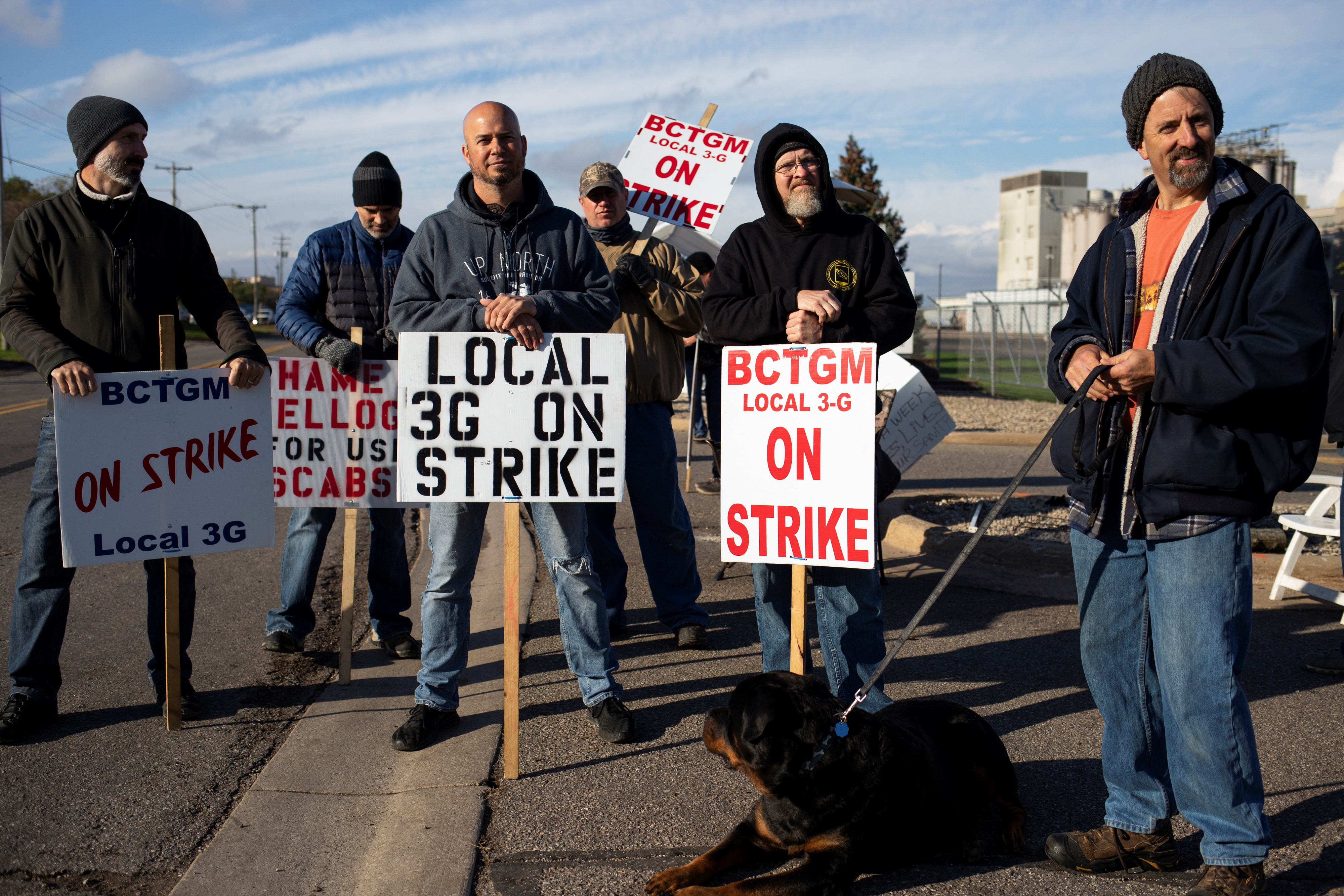 A group of union workers from Kellogg's picket outside the cereal maker's headquarters as they remain on strike in Battle Creek, Michigan, US, October 21, 2021 [Emily Elconin/Reuters]