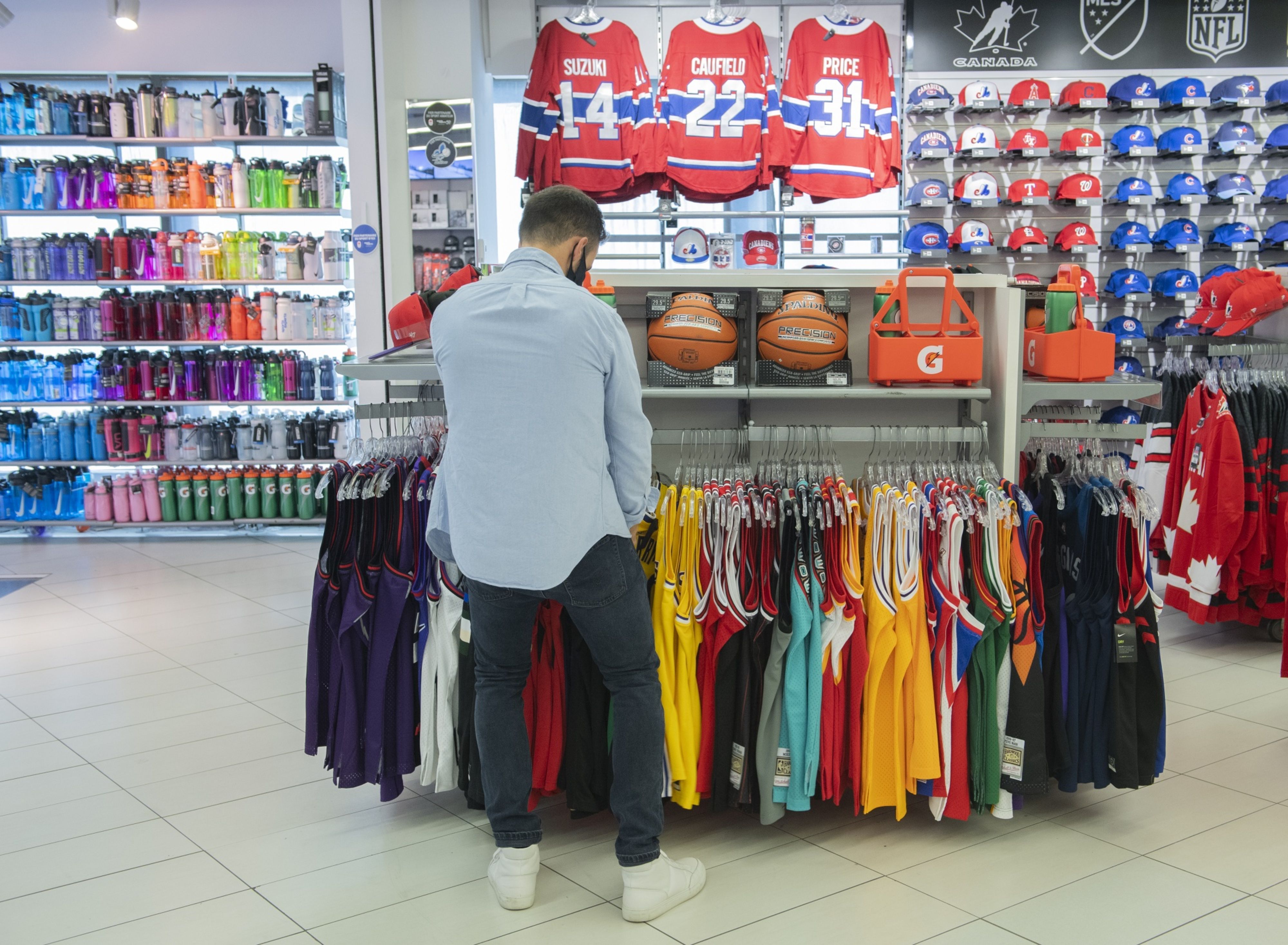 A shopper browses clothing at a Sports Experts store on Sainte-Catherine street in Montreal, Quebec, Canada