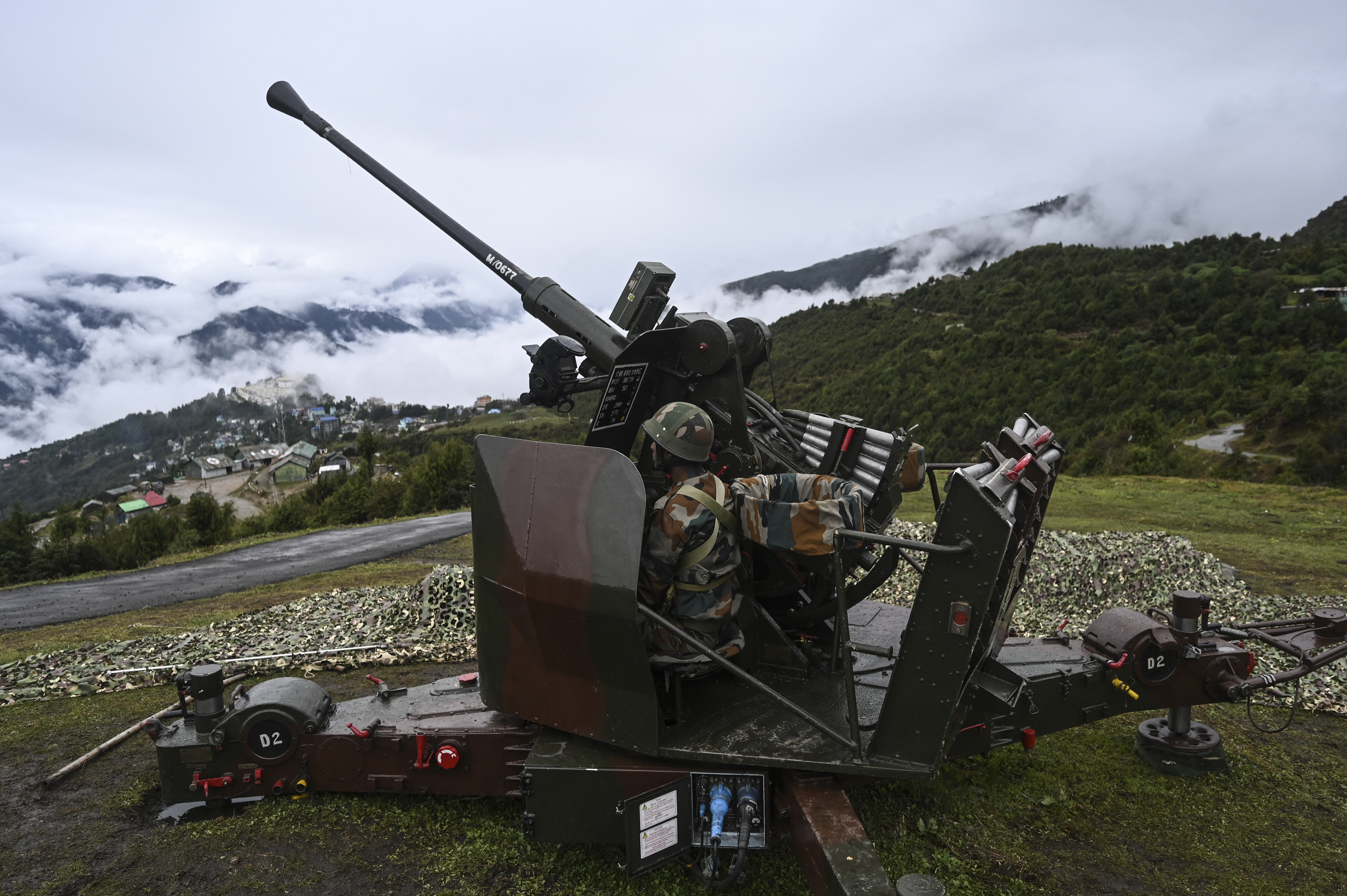 An Indian Army soldier sits inside an upgraded L70 anti aircraft gun in Tawang